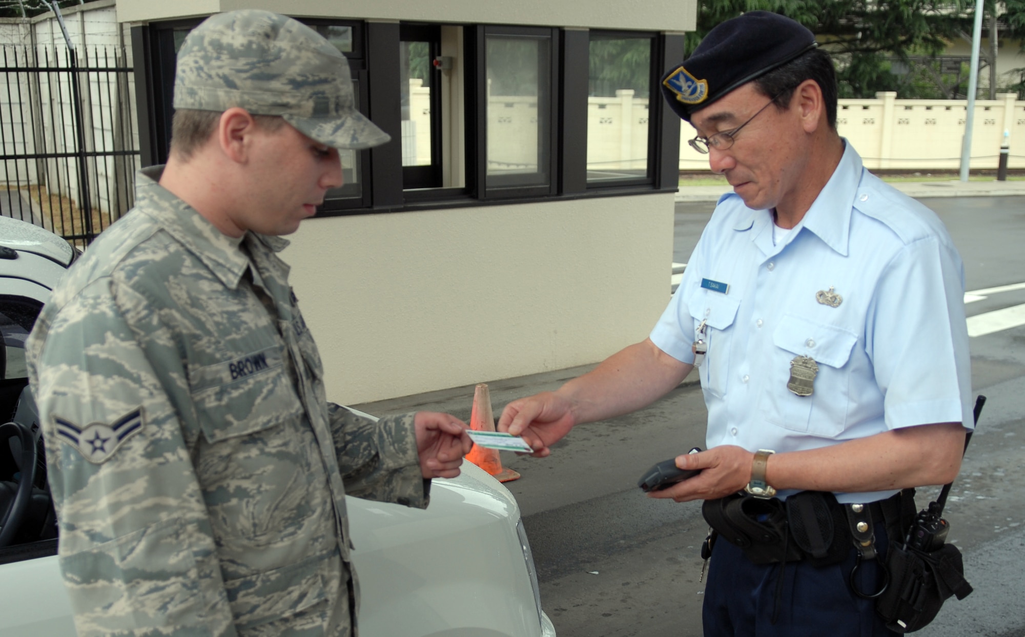 MISAWA AIR BASE, Japan – Airman First Class Jared Brown, 35th Maintenance Squadron munitions equipment maintenance technician, shows a guard his liberty card Aug. 5 at the Friendship Gate. Liberty cards come in two different colors, green for open access and red for restricted access. Members in possession of a red liberty card are required to be back on base by midnight. (Air Force photo/Staff Sgt Phillip Butterfield)