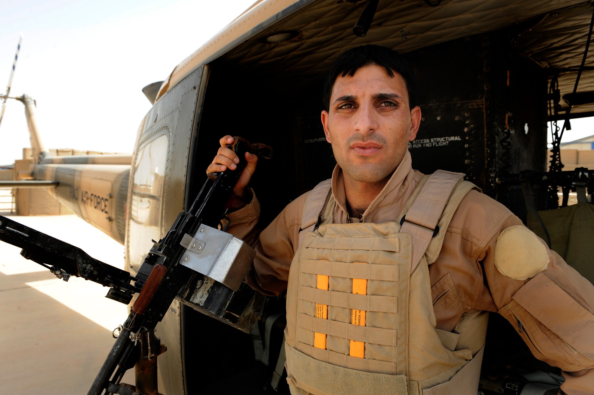 An Iraqi air force aerial gunner prepares for a UH-1H II Huey medical transportation flight at Taji Air Base, Iraq, July 17, 2009.  (U.S. Air Force photo by Staff Sgt. Michael B. Keller) (Released) 
