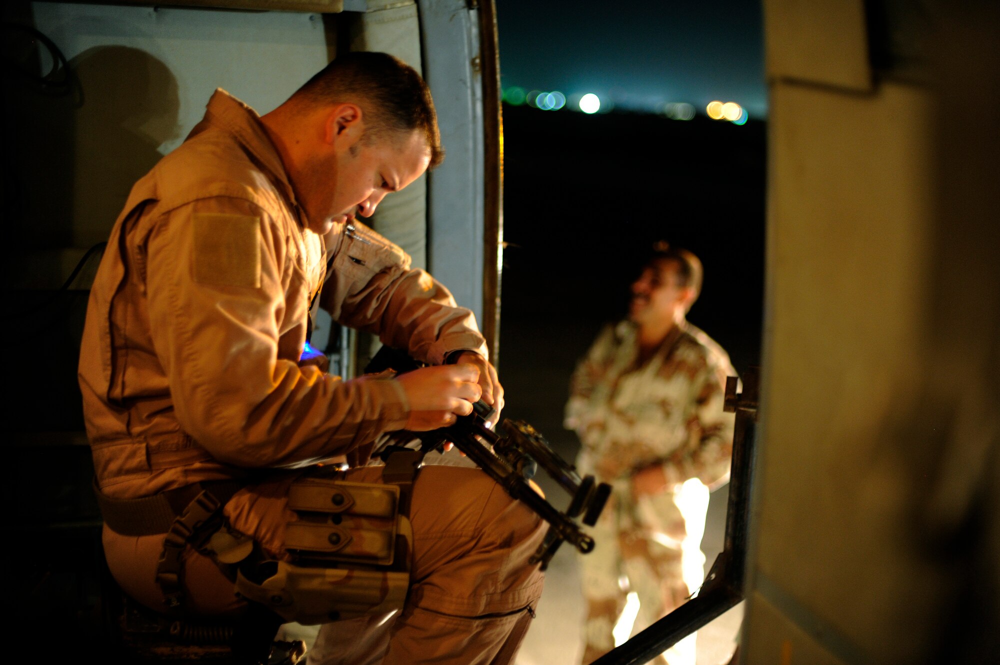 U.S. Air Force Tech. Sgt. Onnez Rodriquez-Massas, an aerial gunner with the 721st Air Expeditionary Advisor Squadron, inspects a PKM machine gun on an Iraqi Mi-171 helicopter prior to a night mission at Camp Taji, Iraq, July 12, 2009.  The 721st trains the Iraqi air force in many functions, including helicopter pilot training and aerial gunner training.  Sergeant Rodriguez-Massas is deployed from Andrews Air Force Base, Md.  (U.S. Air Force photo by Staff Sgt. Michael B. Keller) (Released) 
