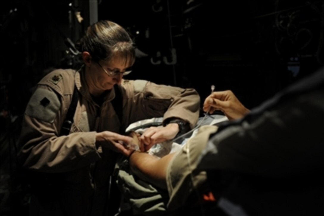 U.S. Air Force Maj. Missy Steckler, a flight nurse assigned to the 451st Expeditionary Aeromedical Evacuation Flight, provides care to a patient during a mission at Kandahar Airfield in Kandahar, Afghanistan, on July 21, 2009.  The patient will be transported to Bagram Airfield in Parwan, Afghanistan.  