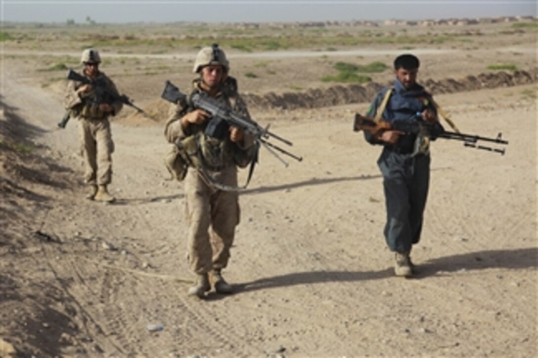 U.S. Marines with Bravo Company, 1st Battalion, 5th Marine Regiment and Afghan National Police officers conduct a security patrol through the Nawa district of Helmand province, Afghanistan, on Aug. 3, 2009.  Marines with 1st Battalion, 5th Marine Regiment, Regimental Combat Team 3, 2nd Marine Expeditionary Brigade-Afghanistan are deployed to support NATO's International Security Assistance Force and will participate in counter insurgency operations.  They will train and mentor Afghan National Security Forces to improve security and stability in the country.  