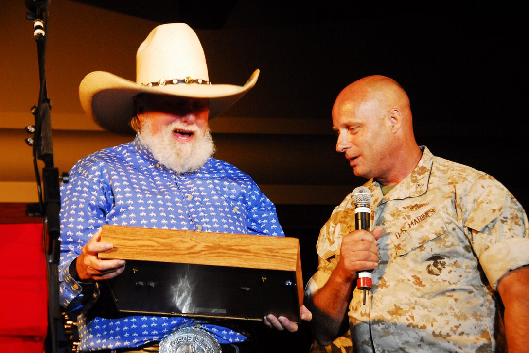 Col. Mark Werth, commanding officer of the Marine Corps Air Station in Yuma, Ariz., presents Charlie Daniels with a Ka-Bar knife in a shadow box in appreciation of his performance at the station Aug. 6, 2009. Approximately 500 people attended the free event.