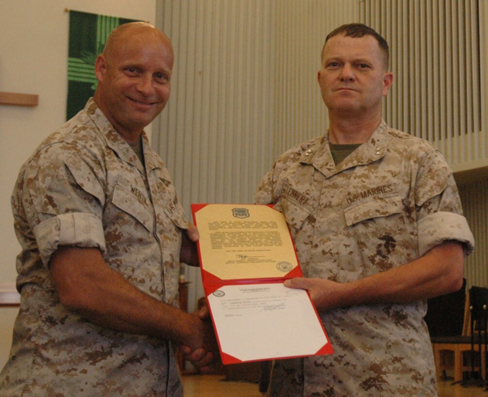 Col. Mark Werth, Marine Corps Air Station Yuma commanding officer, left, is presented the Chief of Naval Operations Aviation Safety Award by Maj. Gen. Michael Lehnert, Marine Corps Installations West commanding general, Aug. 6, 2009, at the station's chapel. The air station was the only installation to be given the award in 2008. “Winning this award is a testament to your abilities to turn things around,” said Lehnert, referring to the accident in 2007 when seven Marines lost their lives in a helicopter crash.
