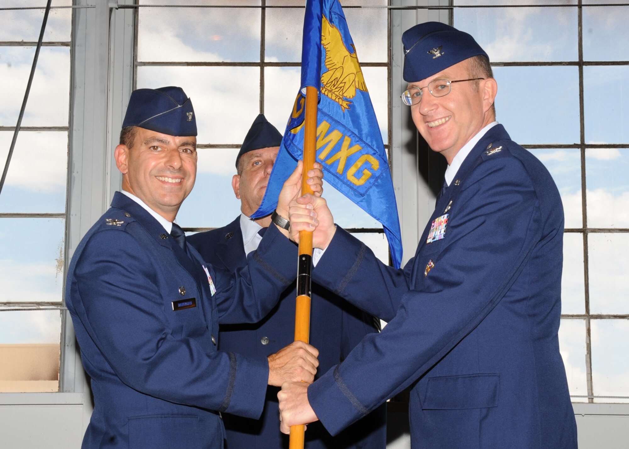 HOLLOMAN AIR FORCE BASE, N.M. -- Col. Jeff Harrigian, 49th Fighter Wing commander, passes the command guidon of the 49th Maintenance Group to Col. Donald Van Patten in a change-of-command ceremony here Aug. 6. Colonel Van Patten succeeded Col. George Torres Jr., who served as the 49th MXG commander for the past two years. (U.S. Air Force photo by Senior Airman Michael Means)