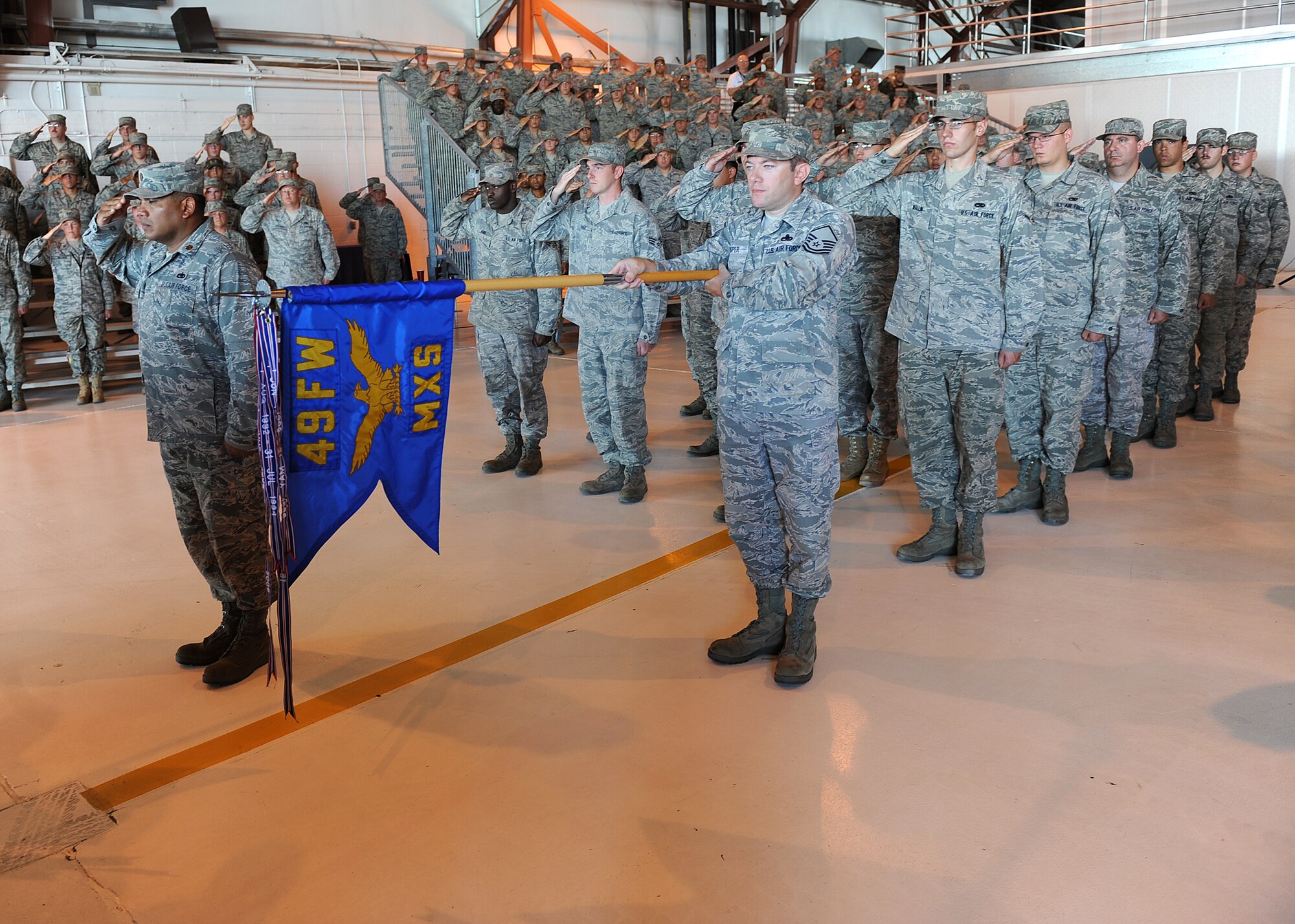 HOLLOMAN AIR FORCE BASE, N.M. -- Members of the 49th Maintenance Squadron stand in formation and render their first salute to their new commander, Col. Donald Van Patten, during a change-of-command ceremony here Aug 6. Colonel Van Patten succeeded Col. George Torres Jr., who will become the director of maintenance for Global Strike Command, at Barksdale AFB, La. (U.S. Air Force photo by Senior Airman Michael Means)
