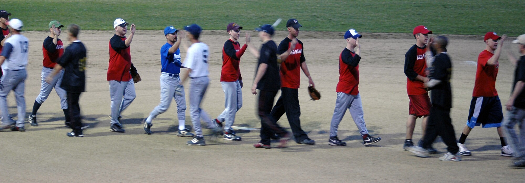 Members of the 12th Missile Squadron high-five 341st Maintenance Operation Squadron members after beating them 12 to 1 in five innings to capture the intramural slow-pitch softball championship Aug. 4. (U.S. Air Force photo/Senior Airman Dillon White)