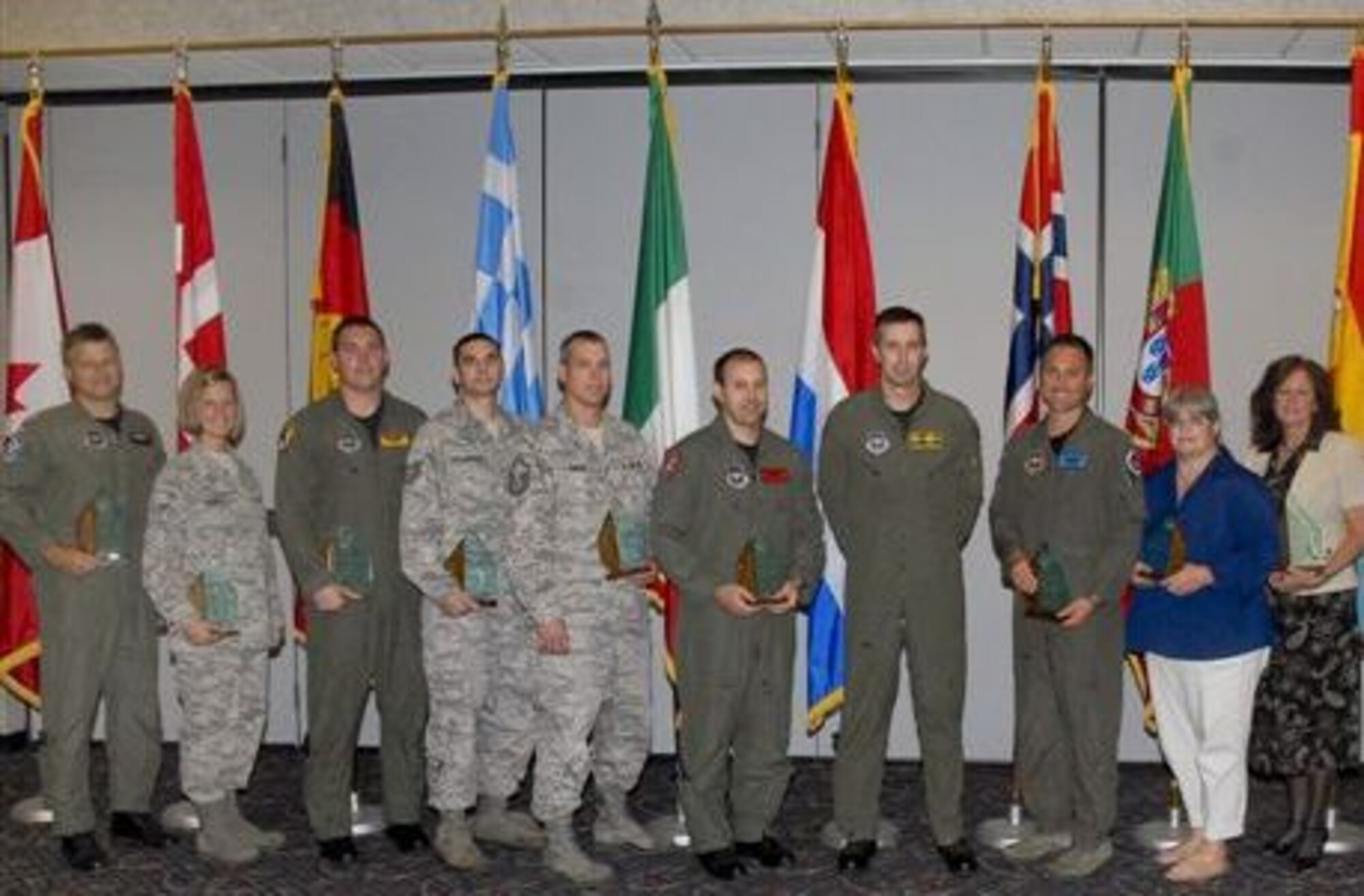 The 80th Flying Training Wing  quarterly award winners pose with their awards July 28 with 80th FTW Commander Col. Kevin Schneider. From left to right: Capt. Timo Schnoebbe, 88th Fighter Training Squadron, Airman 1st Class Katherine Bainey, 80th Operations Support Squadron, 1st Lt. Jeff Carter, 90th FTS, Tech. Sgt. Tommie Schexnayder, 80th FTW, Master Sgt. Eric Smith, 80th OSS, 1st Lt. Justin Thompson, 89th FTS, Colonel Schneider, Maj. Daniel Dorson, 80th OSS, Sandy Snyder, 80 FTW, and Pam Glendening, 80th Operations Group. (U.S. Air Force photo/Harry Tonemah)