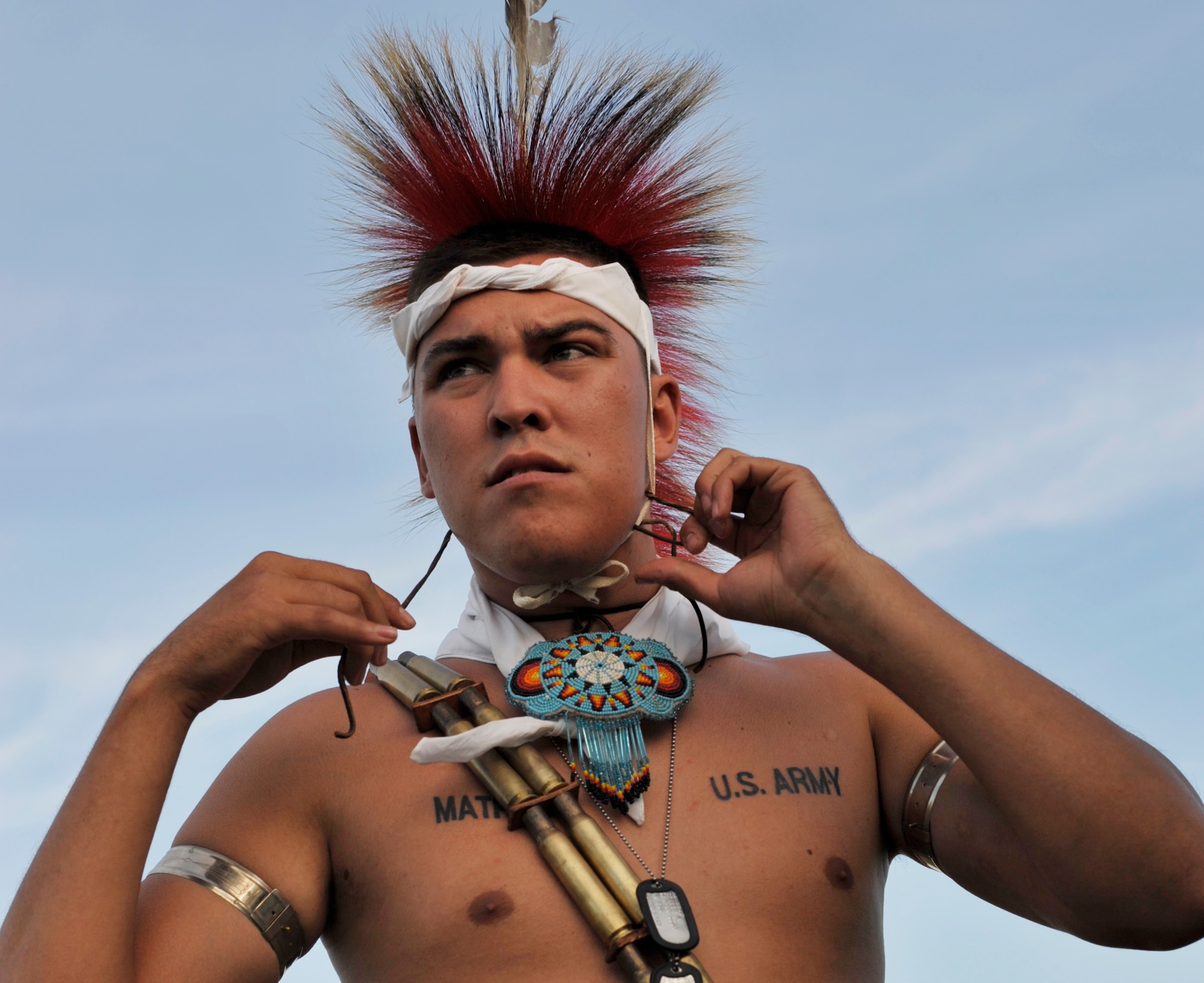 U.S. Army Pvt. Skyler Mathews ties a Kanza roach, or headdress, to his head while preparing to dance during his tribe's annual pow wow near Kaw City, Okla., on Aug. 2, 2009. Pvt. Mathews is an infantryman in the Army National Guard and member of the Kaw Nation, a sovereign Native American tribe headquarted in Kaw City. Like its home state of Kansas, the 931st Air Refueling Group draws its identity from the proud Kanza people of the Kaw Nation. The tribe's roach has become a symbol of the 931st ARG and "Kanza" is the official call sign assigned to 931st flying missions. (U.S. Air Force photo/Tech. Sgt. Jason Schaap) 
