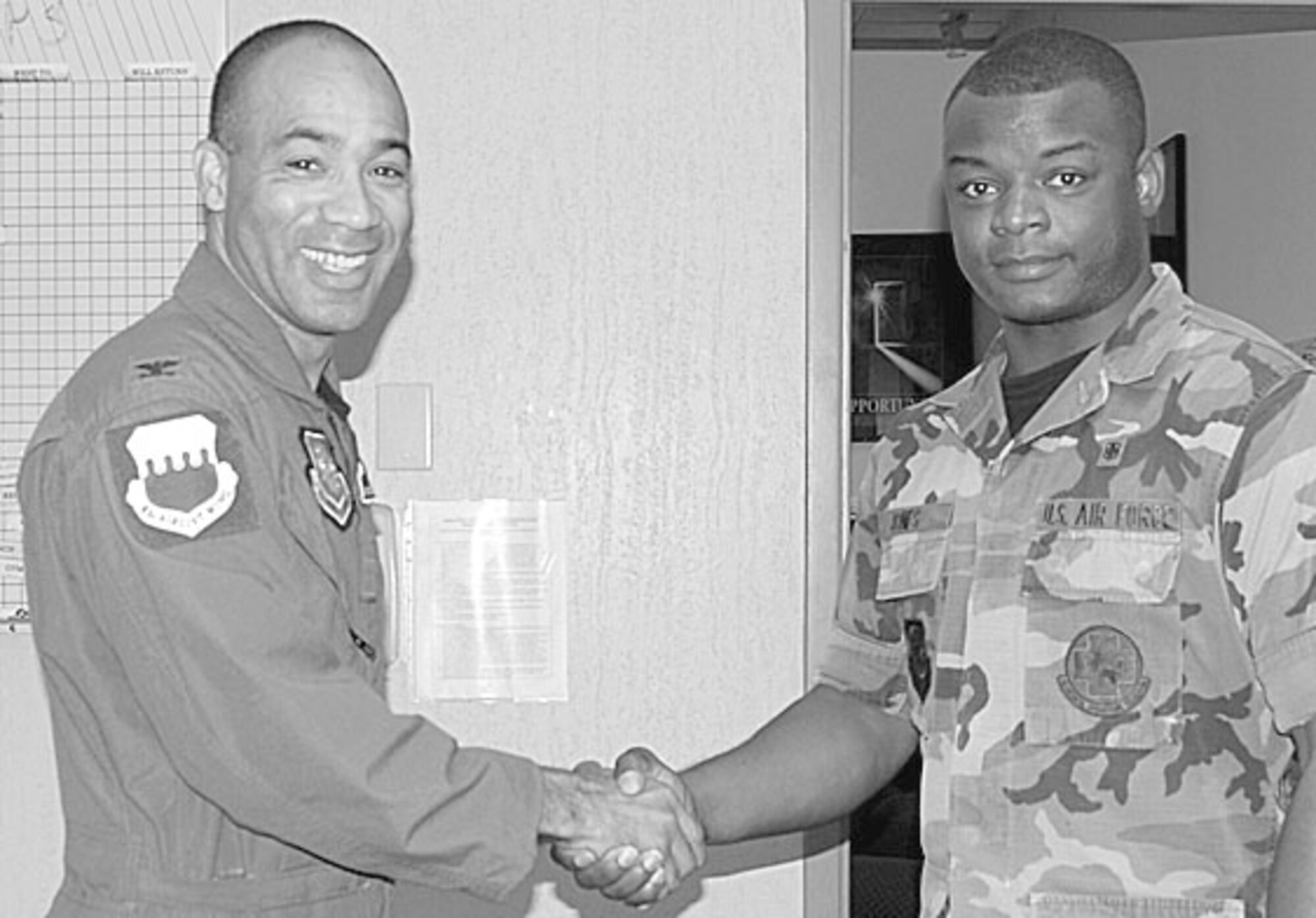 Col. James Johnson, 43rd Airlift Wing Commander, presents his Commander’s Coin to Senior Airman Antonio Jones, 43rd Medical Operations Squadron, Tuesday for his selfless participation in the Drug Education for Youth program as well as his excellent job performance as a Medical Health Technician. (U.S. Photo by 2nd Lt. Cammie Quinn)