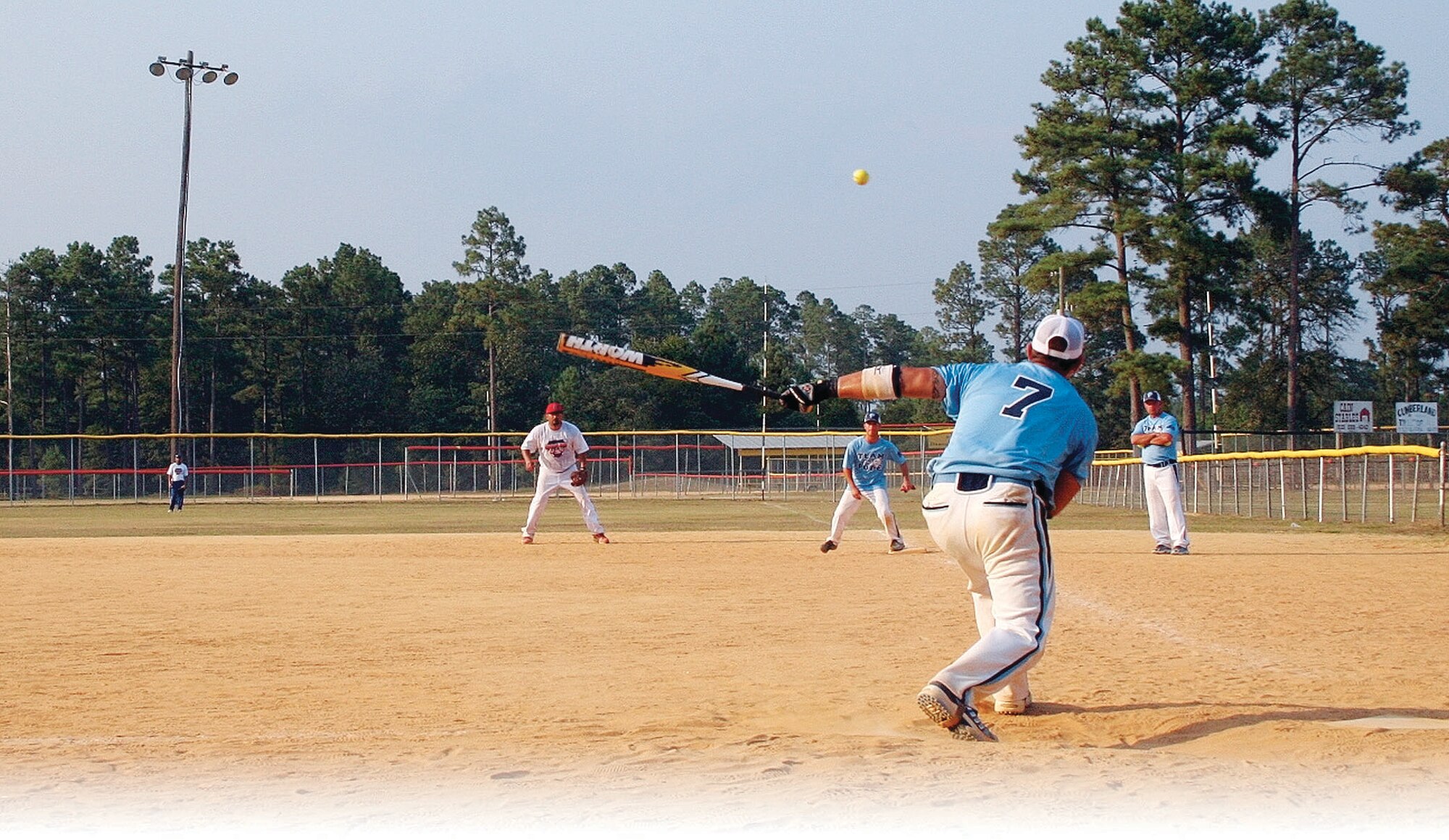 Jay Cortez, shortstop, gets a solid hit down the first base line during the first championship game July 26 against Just Enough. (U.S. Photo Courtesy)