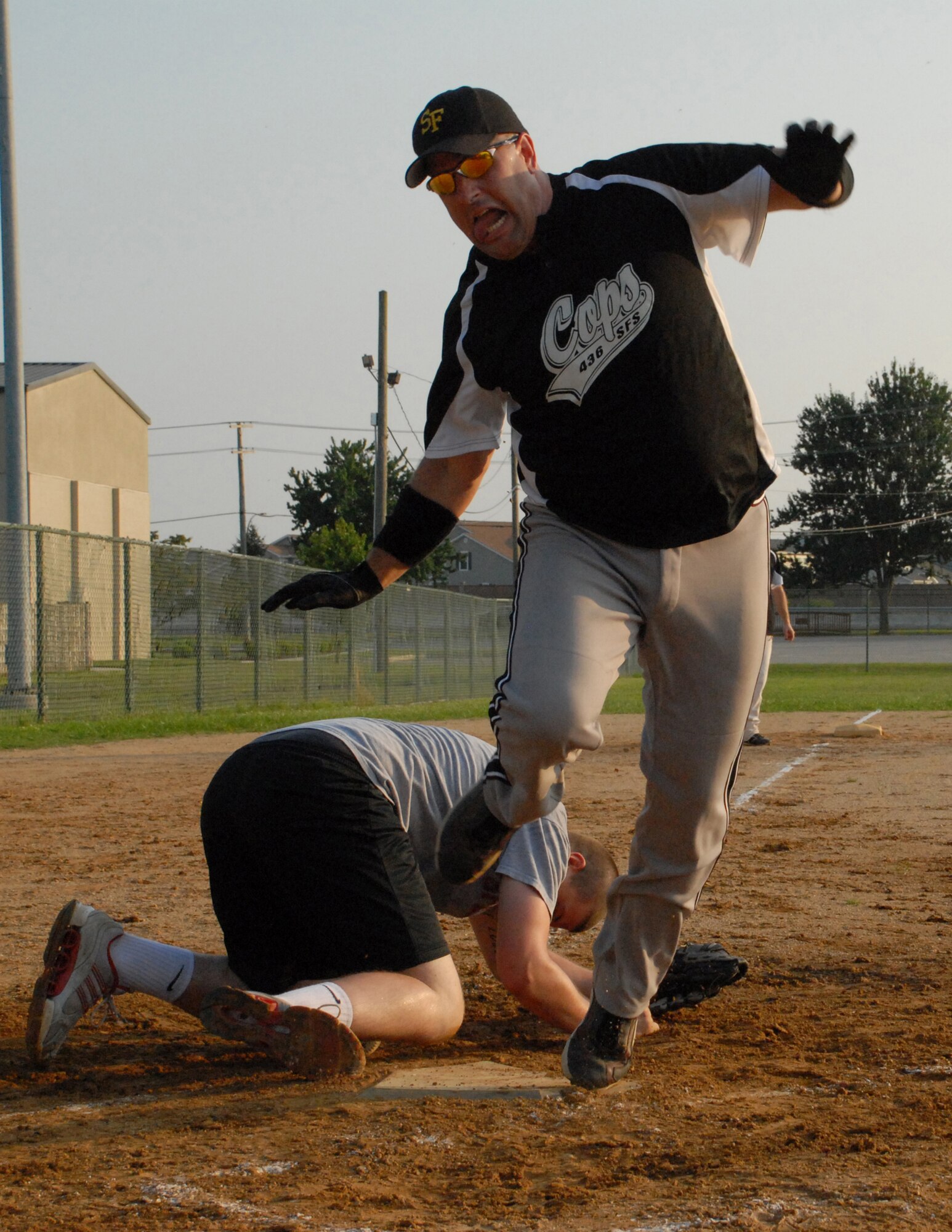 Rick Barker, 436th Security Forces Squadron left fielder, dances on to the home plate during an intramural softball game against the 436th Aerial Port Squadron Aug. 3. The 436th SFS beat 436th APS 10 - 5. (U.S. Air Force photo/Airman 1st Class Matthew Hubby)