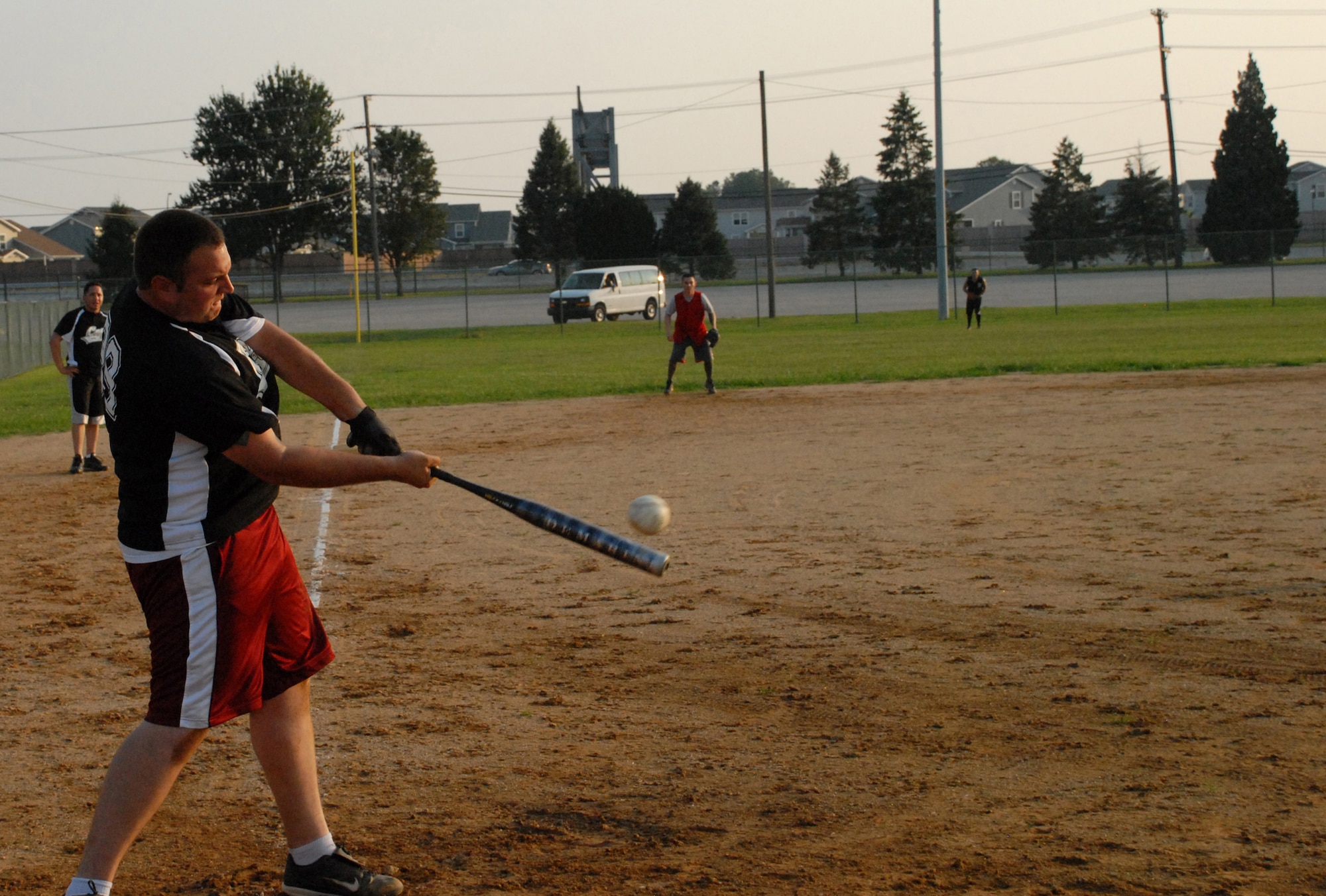 Daniel Reese, 436th Security Forces Squadron, swings into a pop up during an intramural softball game against the 436th Aerial Port Squadron Aug 3. The 436th SFS beat 436th APS 10 - 5. (U.S. Air Force photo/Airman 1st Class Matthew Hubby)