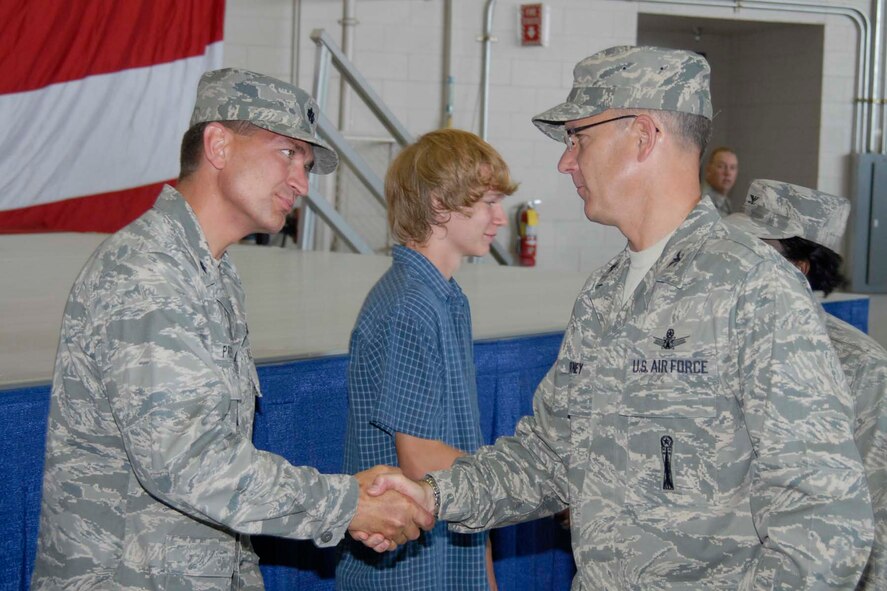 Col. Michael Fortney, 341st Missile Wing commander, congratulates Lt. Col. Jeffrey Pruss after he accepted command of the nwely activated 16th Munitions Squadron Aug. 4. The 16th MUNS will be a tenant unit at Malmstrom, executing the logistical operations of the weapons storage area for the wing commander here. (U.S. Air Force photo/Beau Wade)