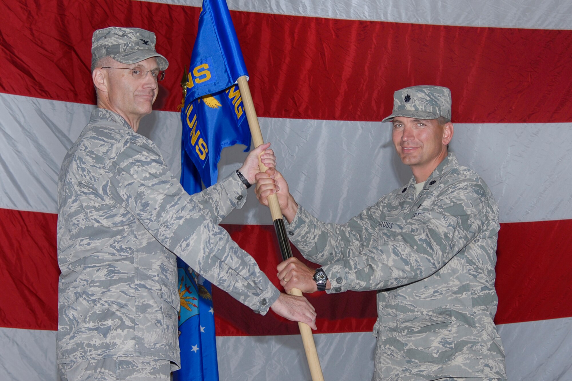 Lt. Col. Jeffrey Pruss assumes command of the 16th Munitions Squadron from Col. David Milner, 798th Munitions Maintenance Group commander, Aug. 4 at the 3-Bay Hangar. Colonel Milner is assigned to Minot Air Force Base, N.D. (U.S. Air Force photo / Beau Wade)