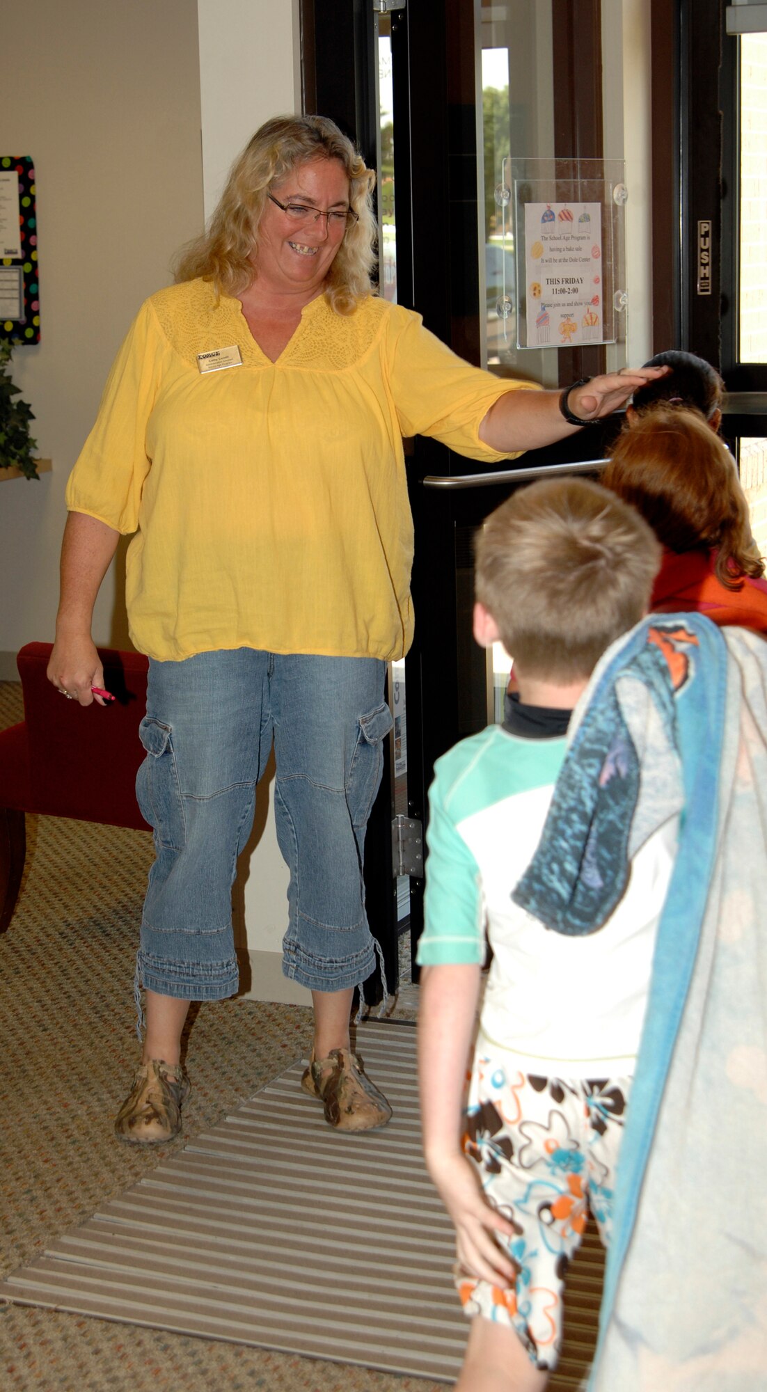 Cathy Condit, School Age Program administrative assistant, counts children as they head off to the base pool, Aug. 4. The School Age Program runs all year and is a place for children to learn and play afterschool or during the summer months while parents work. (U.S. Air Force photo/Senior Airman Laura Suttles)