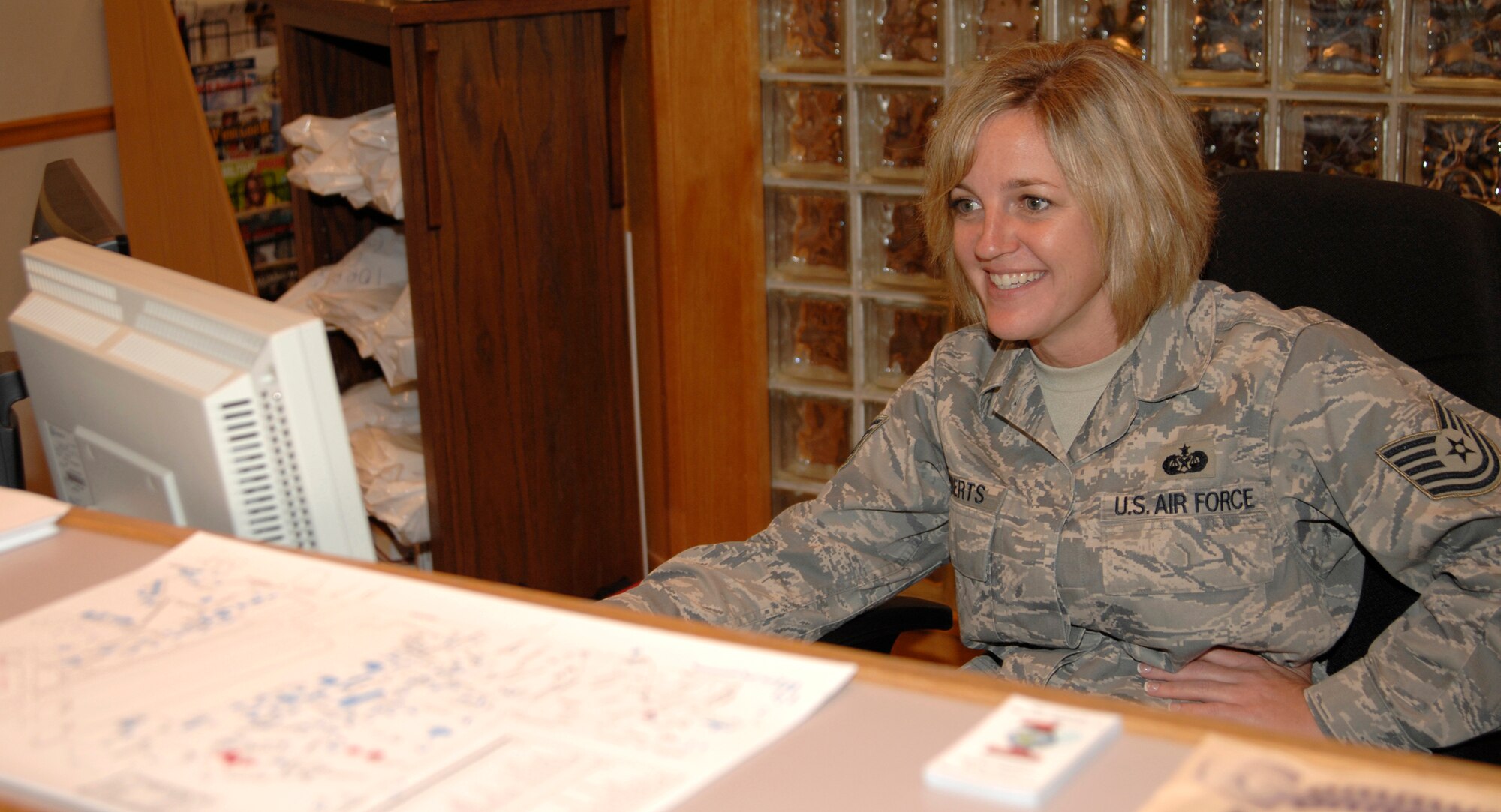 Tech. Sgt. Beth Roberts, 22nd Force Support Squadron, mans the front desk at the Airman and Family Readiness Center, Aug. 4. The Airman and Family Readiness Center is responsible for ensuring all McConnell members, military and family, are taken care of in conjunction with deployments and daily life. (U.S. Air Force photo/Senior Airman Laura Suttles)