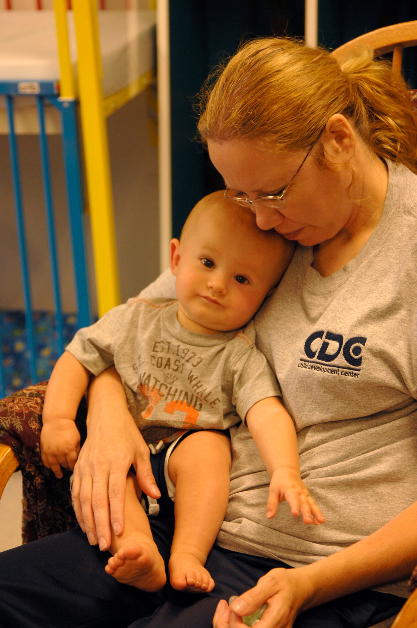 Gail O’Conner rocks Tayden Jagger, nine months, to sleep after lunch at the Child Development Center, Aug. 4. The CDC has more than 195 children in attendance and 57 staff members. (U.S. Air Force photo/Senior Airman Laura Suttles) 