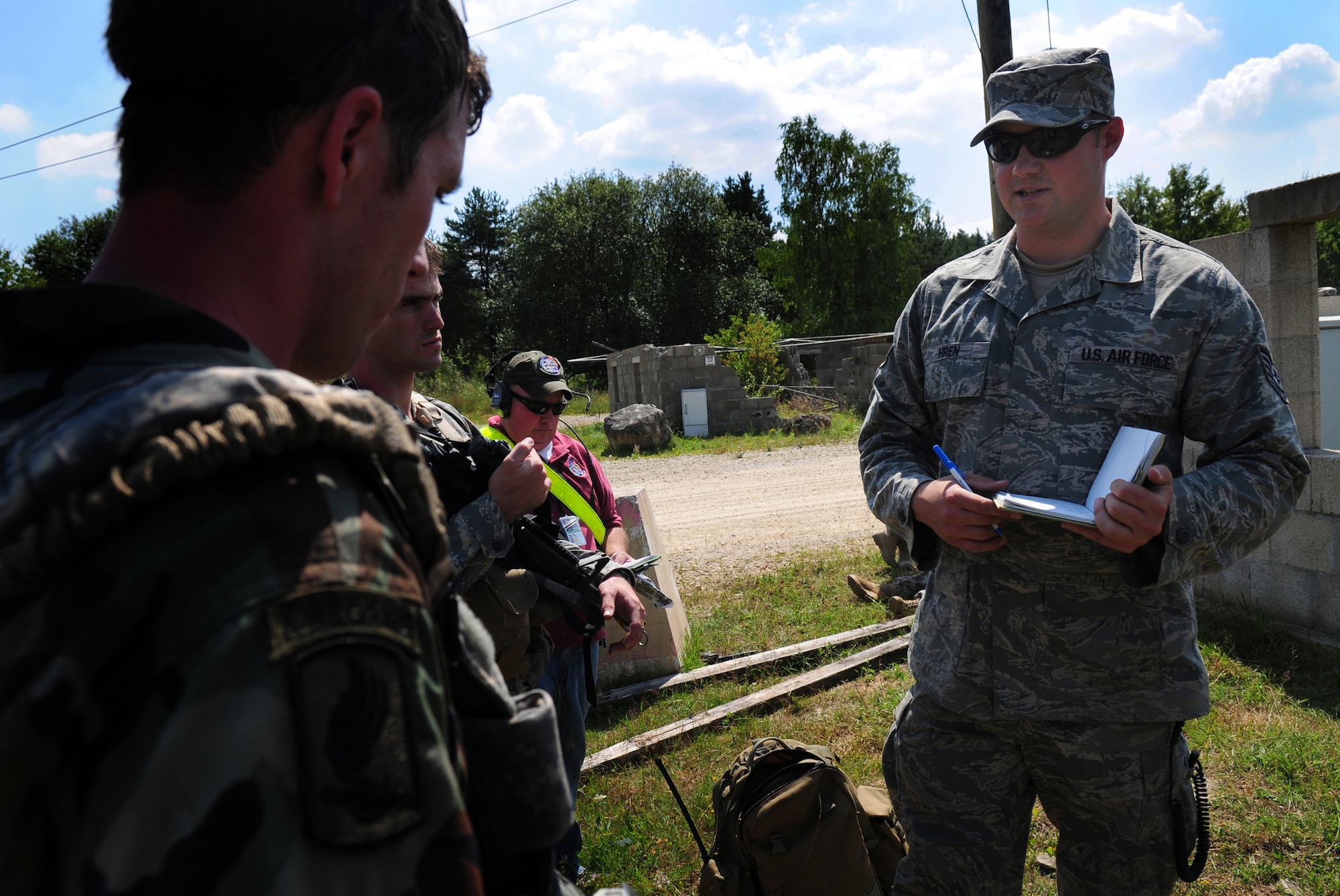 U.S. Air Force Tech. Sgt. Joseph Hren, joint terminal attack controller from the 1st Air Support Operations Squadron, Wiesbaden, Germany gives a tactical air party immediate feedback on their performance in a close air support simulated mission as a part of Allied Strike in Hohenfeld, Germany, Aug. 5, 2009.  Allied Strike a multi-service, multi-national exercise presents realistic scenarios geared specifically toward TACP to hone skills before deploying. (U.S. Air Force photo by Staff Sgt. Jocelyn Rich) 