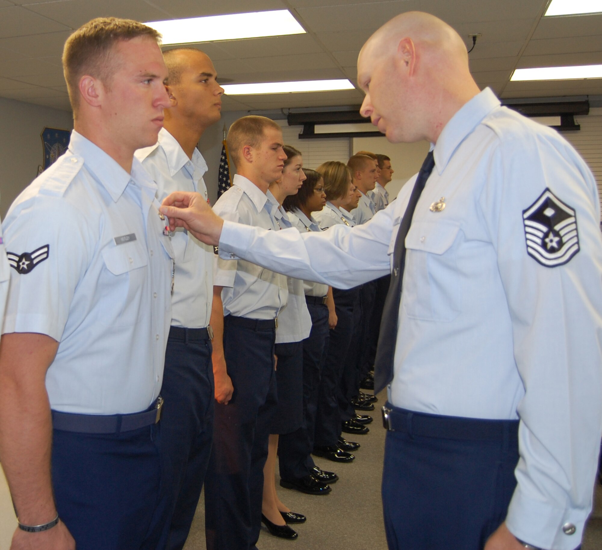 Master Sgt. Joel Peacock, 341st Security Support Squadron first sergeant, inspects uniforms at the First Term Airmen Center Aug. 3. The newly arrived Malmstrom Airmen participate in the five-day long course designed to transition them from a training mindset to a mission-oriented environment. (U.S. Air Force photo/Staff Sgt. Eydie Sakura)