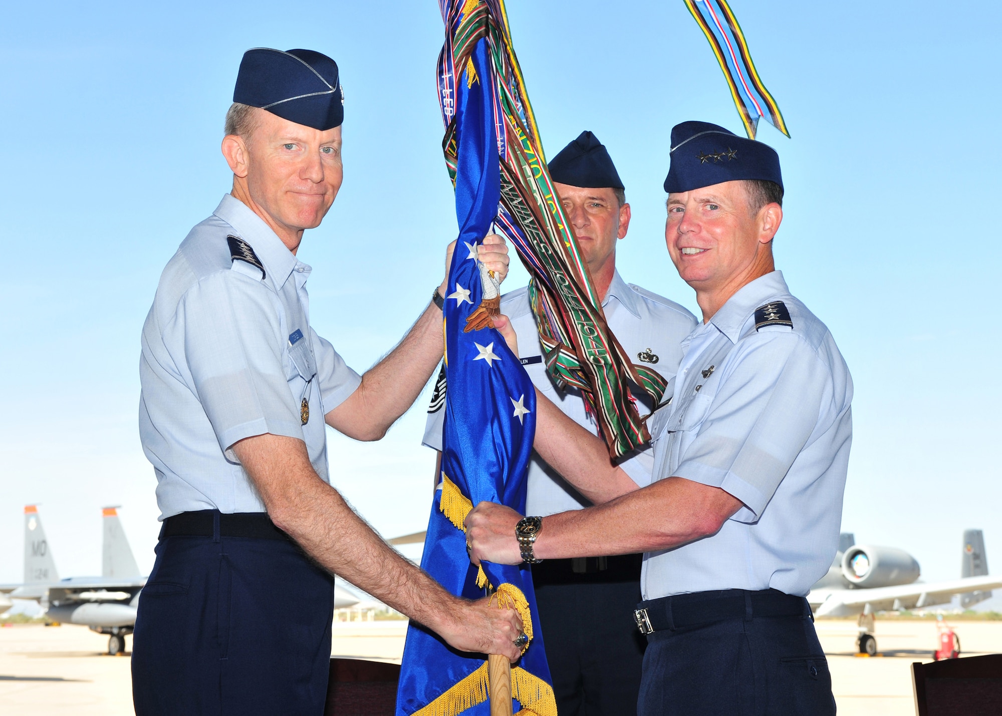 DAVIS-MONTHAN AFB, Ariz. -- Gen. John Corley, Air Combat Command commander (left), bestows the 12th Air Force (Air Forces Southern) guidon to Lt. Gen. Glenn Spears as he took command of the unit during a ceremony here Aug 7.  General Spears assumed command from Lt. Gen. Norman Seip.  (U.S. Air Force photo by Senior Airman Noah Johnson)