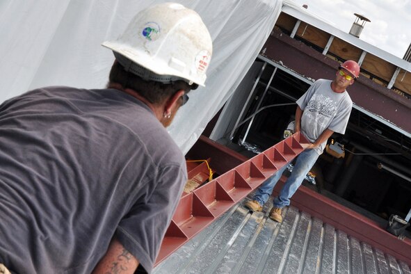 EGLIN AIR FORCE BASE, Fla. --  Construction workers move steel beams into place on the roof of the Eglin Commissary during an extensive renovation and expansion effort to upgrade the entire building Aug. 6. Scheduled for completion in the summer of 2010, the 19-month project hopes to better meet the needs of the customer and update many of the aging areas in the building. This means expansion of the sales floor by 6,000 square feet, a second commissary entrance, parking area and roof. (U.S. Air Force photo/ Airman Anthony Jennings)