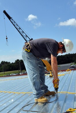 EGLIN AIR FORCE BASE, Fla. --   A construction worker secures panels on the roof of the Eglin Commissary during an extensive renovation and expansion effort to upgrade the entire building Aug. 6. Scheduled for completion in the summer of 2010, the 19-month project hopes to better meet the needs of the customer and update many of the aging areas in the building. This means expansion of the sales floor by 6,000 square feet, a second commissary entrance, parking area and roof. (U.S. Air Force photo/ Airman Anthony Jennings)