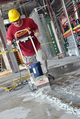 EGLIN AIR FORCE BASE, Fla. --  A construction worker removes tile as part of an extensive renovation and expansion effort to upgrade the Eglin Commissary Aug. 6. Scheduled for completion in summer of 2010, the 19-month project hopes to better meet the needs of the customer and update many of the aging areas in the building. This means expansion of the sales floor by 6,000 square feet, a second commissary entrance, parking area and roof. (U.S. Air Force photo/ Airman Anthony Jennings)