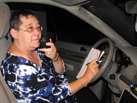 Arnold Engineering Development Center (AEDC) Budget Analyst Carol Pratt, call sign KI4QWM, waits with a notebook and pen for a response to a call she made to another ham radio operator in Alabama. Pratt joined other ‘hams,’ including her husband, Harvey, at the communication center of the Coffee County Emergency Management Agency in Manchester during the annual Bonnaroo Music & Arts Festival in June. (Photo provided)
