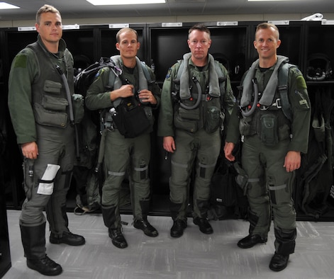 From left to right, Capt. Josh Phifer, 525th Expeditionary Fighter Squadron scheduling officer; Maj. Brad Spears, 3rd Operation Group standardization and evaluation officer and 525th EFS F-22 Raptor pilot; Maj. Brett Paola, 302nd Fighter Squadron chief of weapons; and Lt. Col. Hubie Hegtvedt, 302nd FS commander, prepare for a flight at Andersen Air Force Base, Guam, Aug. 4. The pilots are deployed here to support U.S. Pacific Command’s Theater Security Package mission in the Asia-Pacific region.  (U.S. Air Force photo/Senior Airman Christopher Bush)