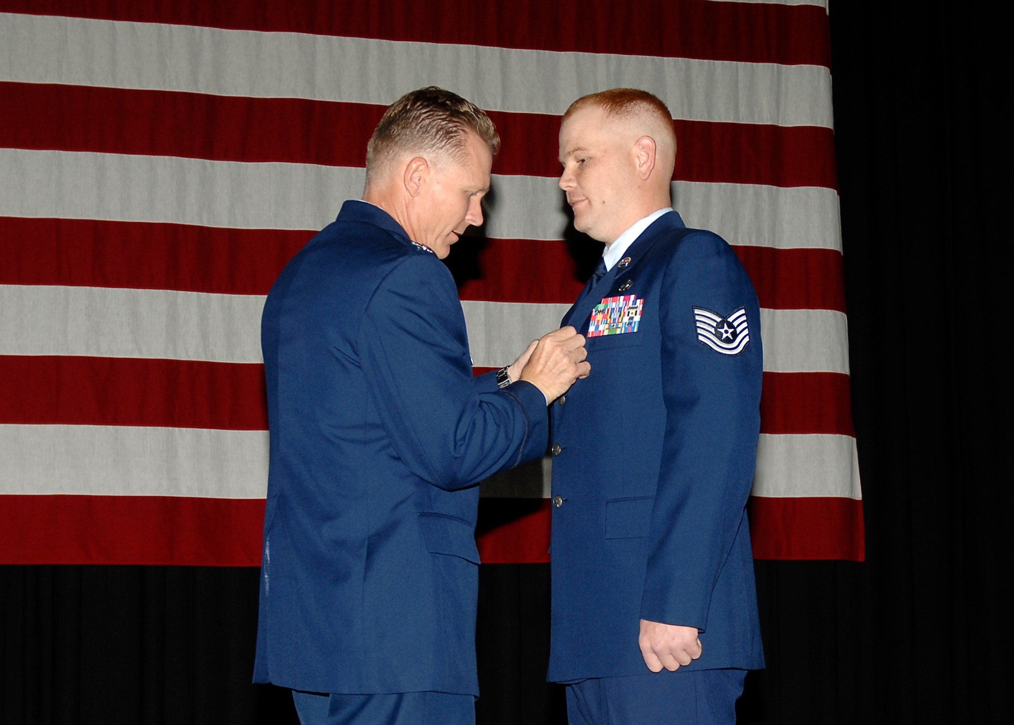 Col. Bart Weiss, 22nd Air Refueling Wing vice commander, presents Tech. Sgt. Joshua Brown, 22nd Logistics Readiness Squadron chief dispatcher, with a Bronze Star Medal during a promotion ceremony July 31, 2009, McConnell Air Force Base, Kan. Sergeant Brown received his medal for providing critical mission needs during his tour in Iraq. (U.S. Air Force photo/Staff Sgt. Anthony Mejia)