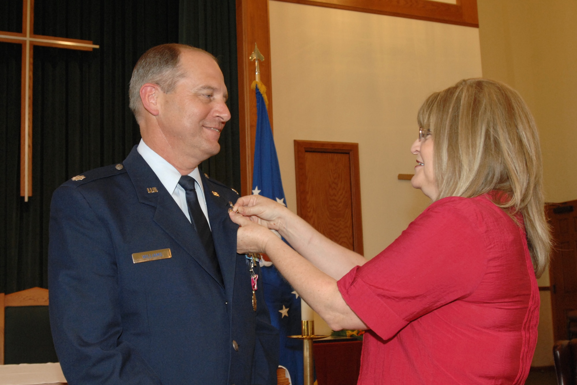 Lt. Col. Michael Williams, 22nd Air Refueling Wing chaplain, receives his retirement pin from his wife, Becky, during his retirement ceremony at McConnell AFB, Kan., on July 30. (U.S. Air Force photo/Staff Sergeant Jamie Train)