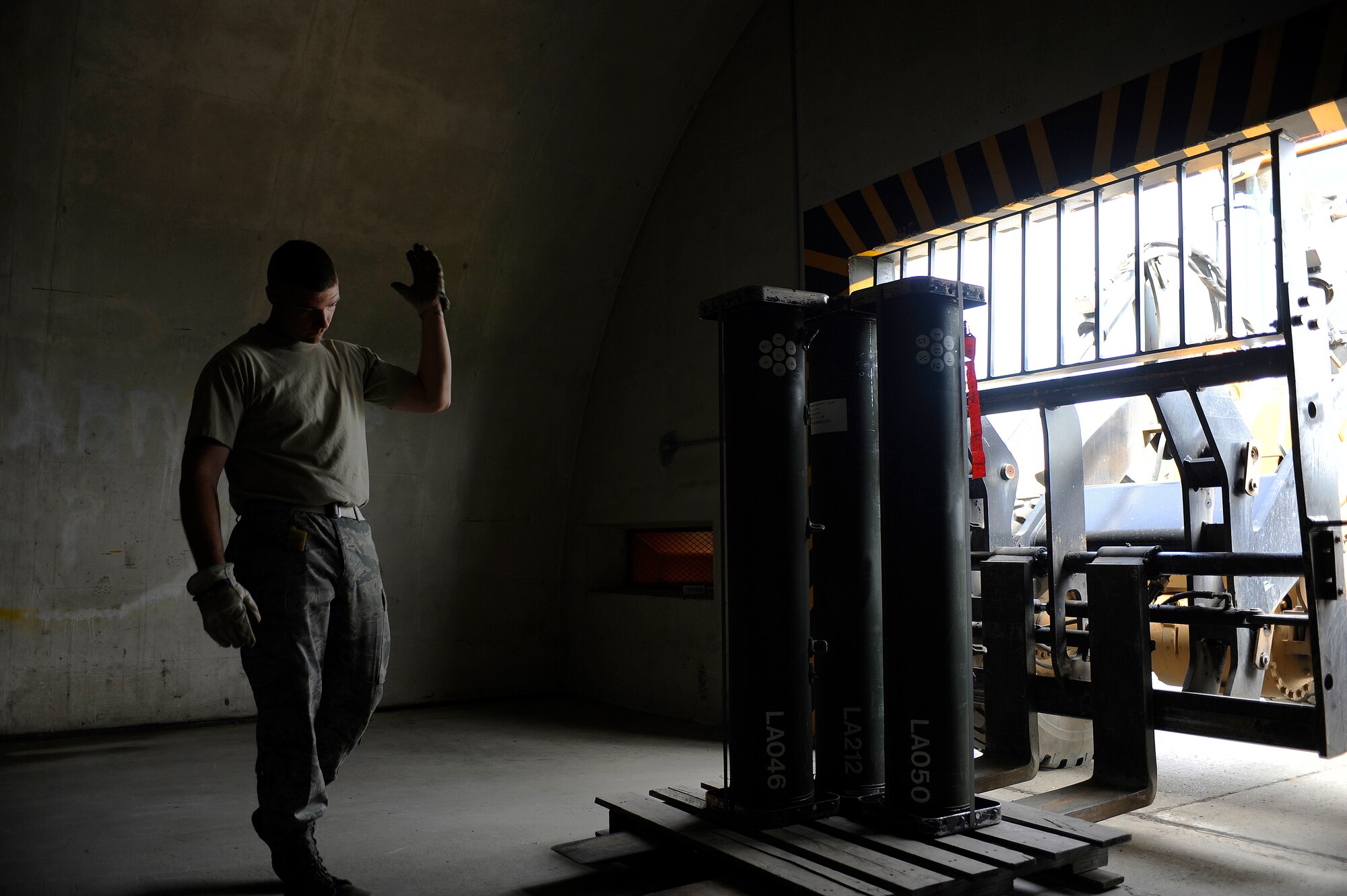 Staff Sgt. Anderw Schott spots Staff Sgt. Benjamin Amen as he removes a pallet of LAU-139 flare dispensers from the storage facility July 29, 2009, Eielson Air Force Base, Alaska. The dispensers needed to be removed to make room for a new shipment. Both sergeants are munitions storage crew members in the 354th Maintenance Squadron. (U.S. Air Force photo/Airman 1st Class Willard E. Grande II)