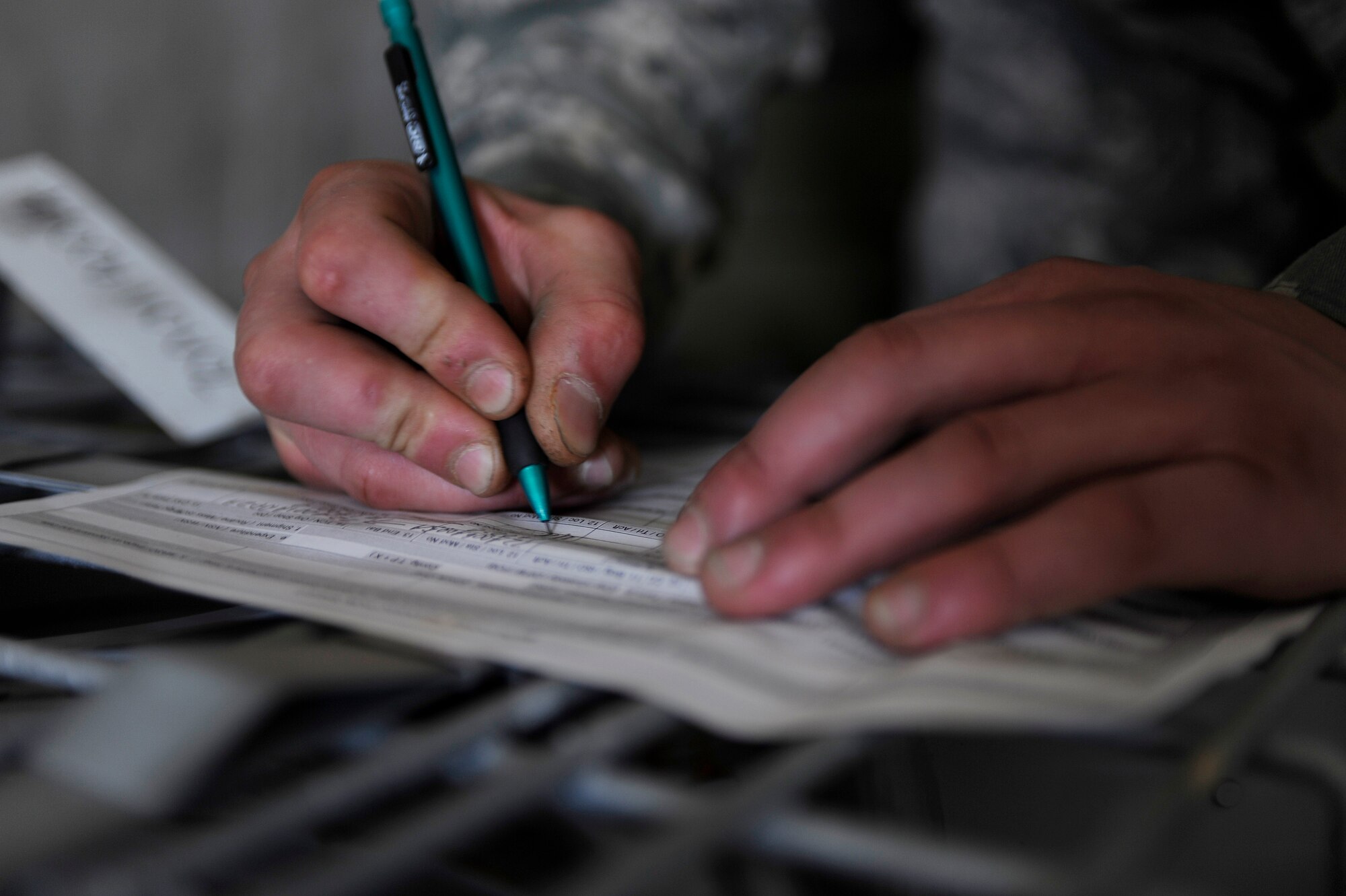 Airman 1st Class Nathaniel Hollister annotates the location of the newly received MAU-93 conical fins July 29, 2009, Eielson Air force Base, Alaska. The location inside the storage facility must be scribed for accountability purposes. Airman Hollister is a munitions storage crewmember in the 354th Maintenance Squadron. (U.S. Air Force photo/Airman 1st Class Willard E. Grande II)