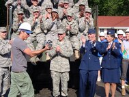 BEAVERCREEK, Ohio -- Ty Pennington, star of the ABC series 'Extreme Makeover: Home Edition", used his "Ty Cam" to interview members of the Air Force team that helped demolish the family's old home Saturday morning. At right are Gen. Donald Hoffman, Lt. Gen Jack Hudson and retired Col. Sue Busler. (Air Force photo by Ron Fry)