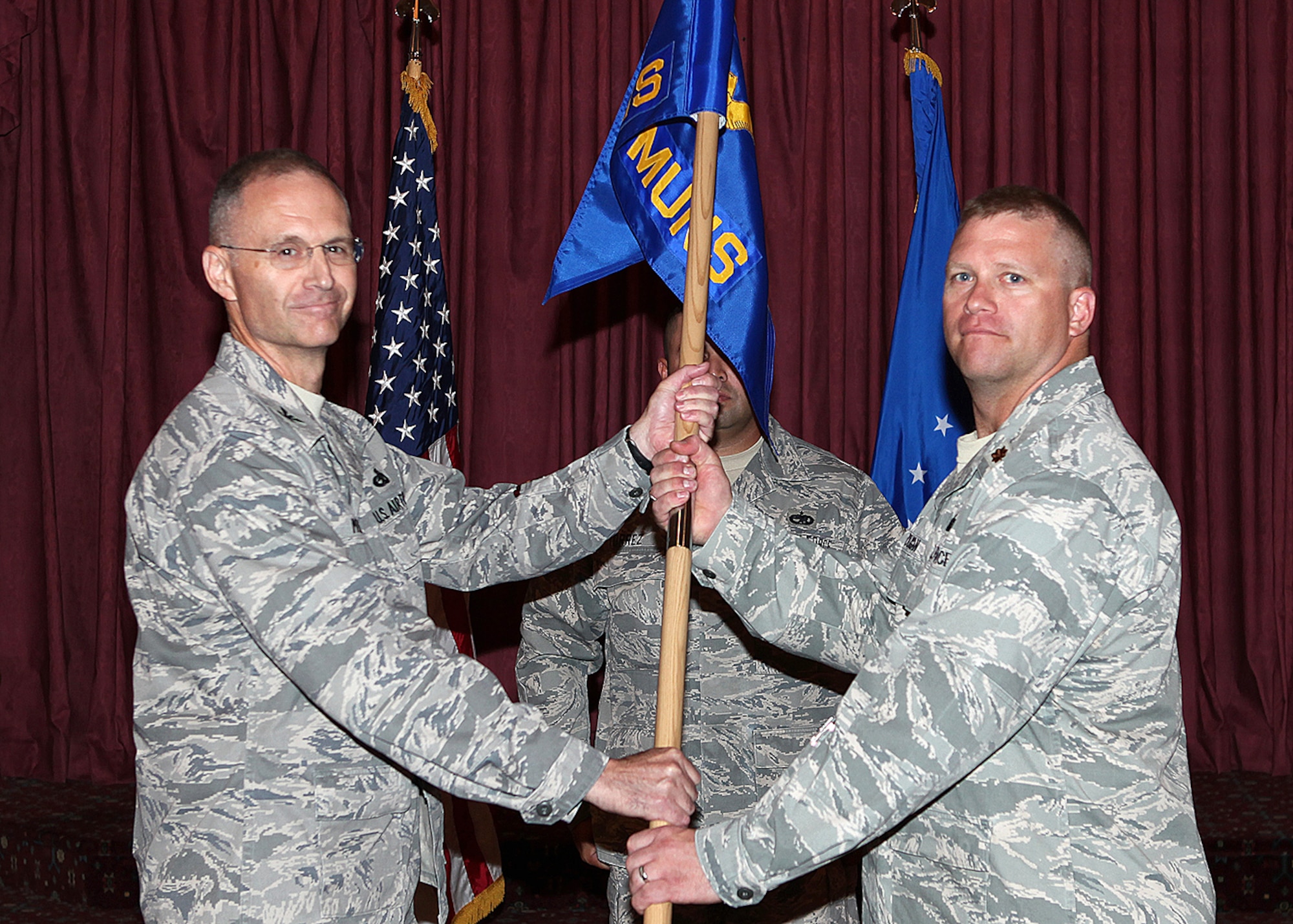 Maj. Jerrod Duggan, 15th Munitions Squadron, accepts the guidon from Col. Dave Milner, 789th Munitions Maintenance Group at the 15th MUNS activation of command ceremnoy Friday.