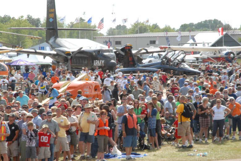 Visitors line up as the C-5M Super Galaxy, The Spirit of Normandy, lands at the EAA AirVenture Oshkosh.  More than 10,000 guests toured the aircraft during The Spirit of Normandy?s two-day visit to the event.  (U.S. Air Force photo/Staff Sgt. Chad Padgett)
