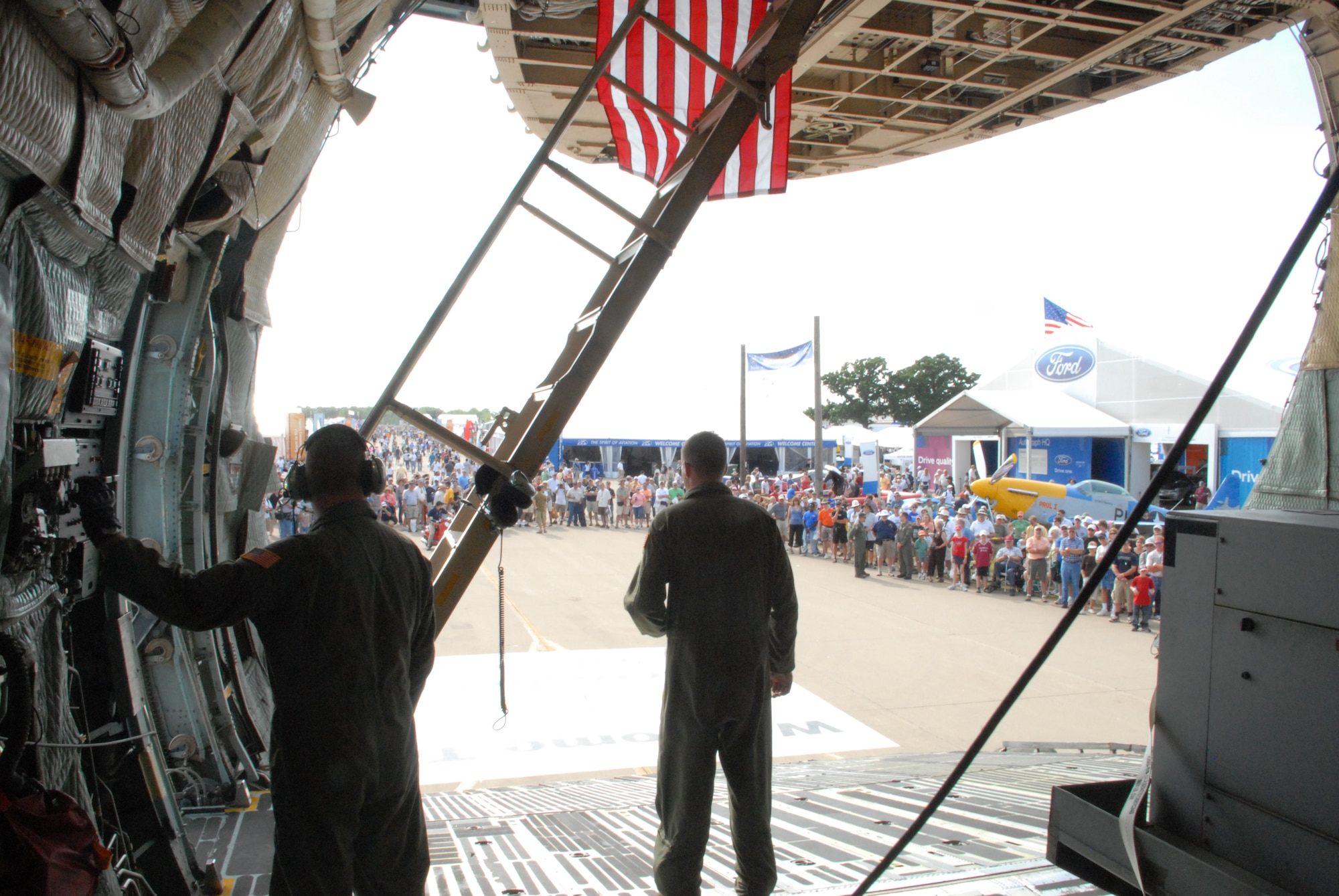 Team Dover members prepare the C-5M Super Galaxy for visitors during the EAA AirVenture Oshkosh.  More than 10,000 guests toured the aircraft during The Spirit of Normandy?s two-day visit to the event.  (U.S. Air Force photo/Staff Sgt. Chad Padgett)