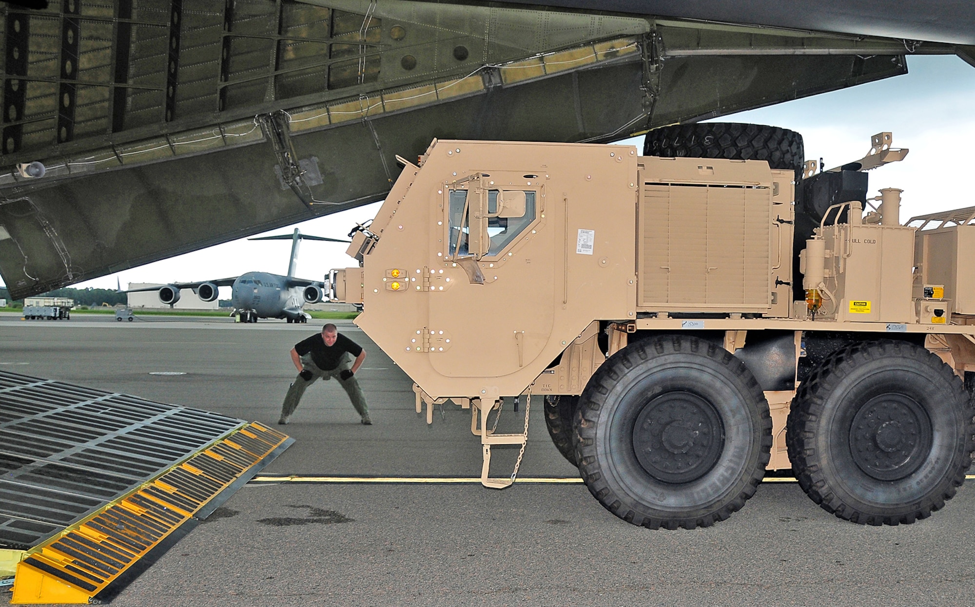 Tech. Sgt. Andrew Cavanaugh supervises the loading of a mine-resistant ambush-protected vehicle onto a C-5 Galaxy July 31 at Charleston Air Force Base, S.C. The MRAP vehicle is a next-generation armored truck and was transported to a deployed location in Southwest Asia. Sergeant Cavanaugh is a loadmaster with the 337th Airlift Squadron from Westover Air Reserve Base, Mass. (U.S. Air Force photo/Staff Sgt. Daniel Bowles)