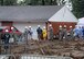 BEAVERCREEK, Ohio -- Volunteers from Wright-Patterson Air Force Base form a bucket-brigade of sorts to help move plants for the Terpenning family's new yard. The August 4 rain was heavy, but did not stop construction on the house. (Air Force photo by Ron Fry)
