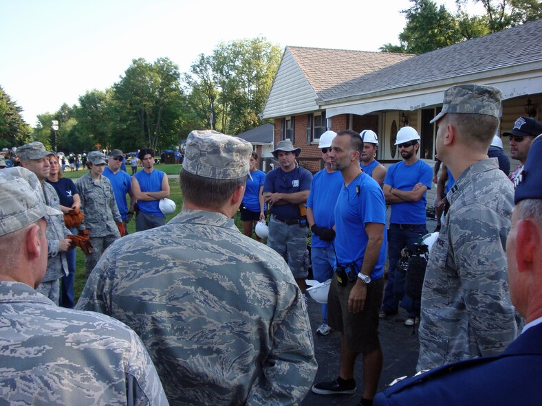 BEAVERCREEK, Ohio -- Crew members from "Extreme Makeover: Home Edition" give instructions to a group of Air Force volunteers.  The AF group was on-hand to remove handicap-accessible fixtures from the Terpenning house before it was demolished.  The equipment will be recycled and donated to deserving disabled veterans.  (Air Force photo by Ron Fry)