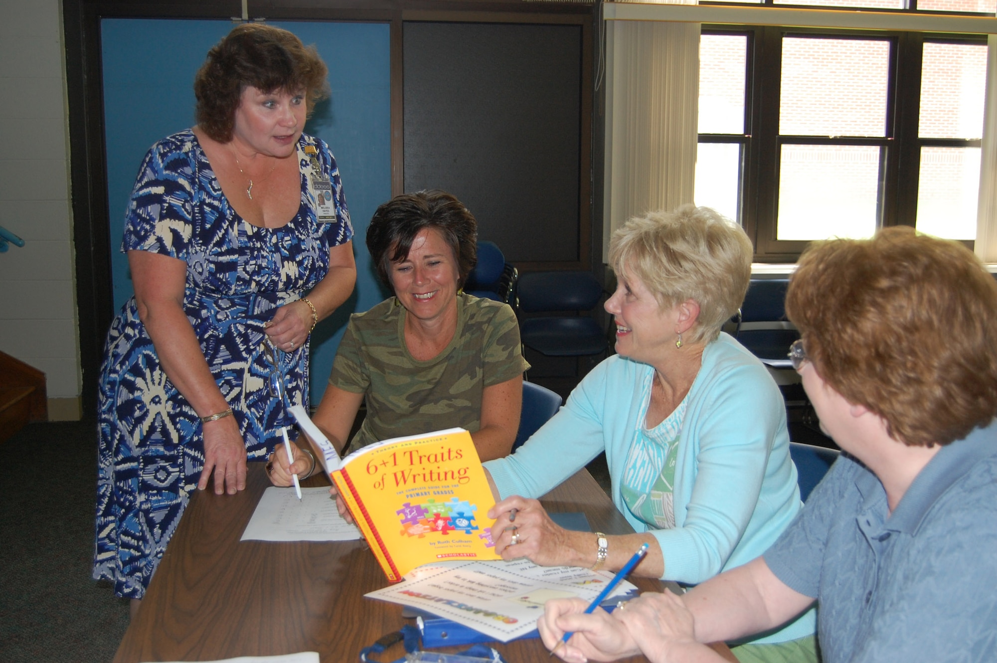 (From left) Maxwell Elementary School principle Melissa Hayes, talks with 2nd grade teacher Katie O'Connor and 3rd grade teachers Louisa Castor and Brenda Hill during a workshop at the school Tuesday. The workshop was part of final preparations for the school's opening today. (U.S. Air Force photo/Carl Bergquist)