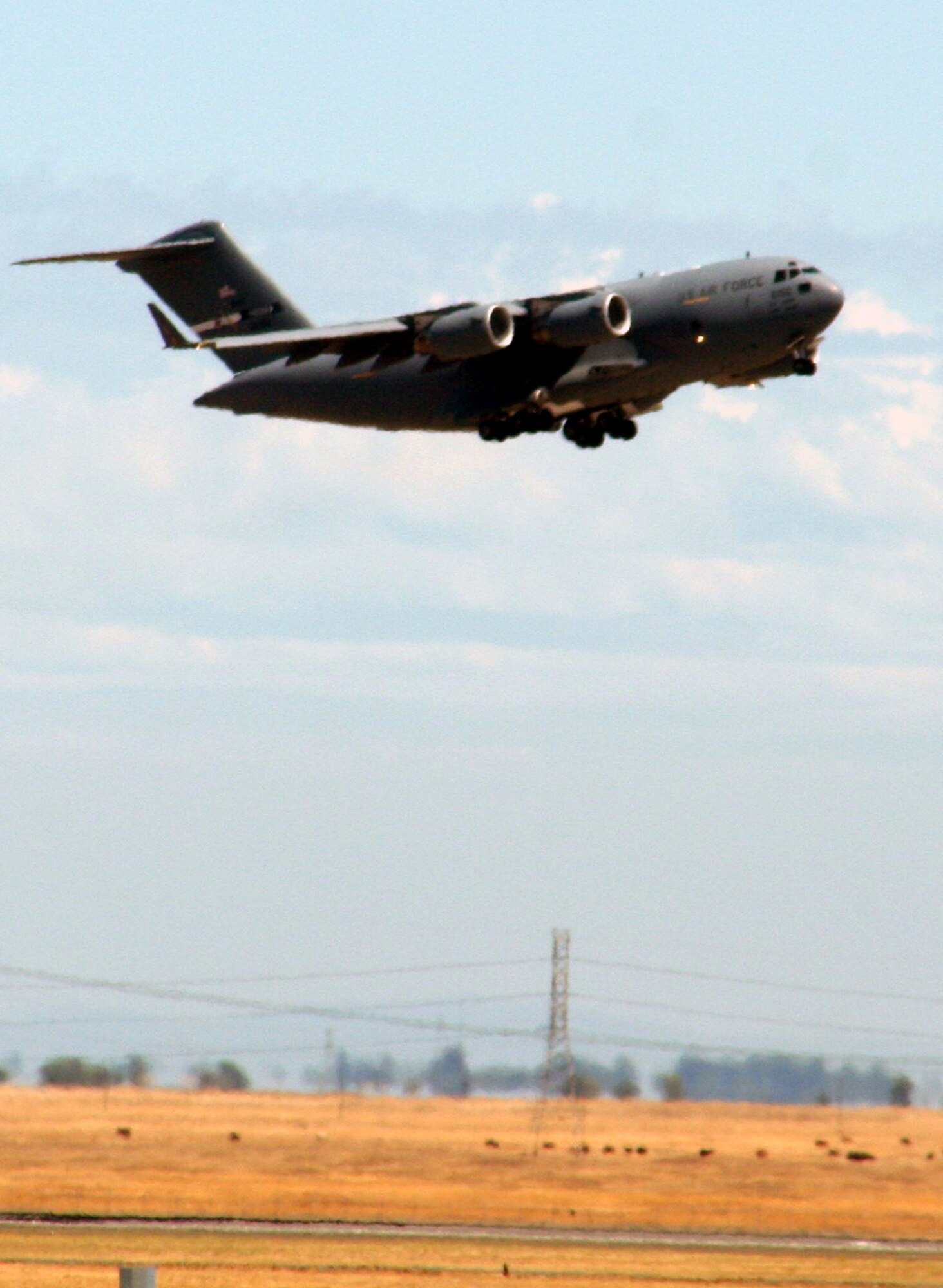 A C-17 Globemaster III takes off for a mission from Travis Air Force Base, Calif., on Aug. 5, 2009. The C-17 . The C-17 Globemaster III is the newest, most flexible cargo aircraft to enter the airlift force. The C-17 is capable of rapid strategic delivery of troops and all types of cargo to main operating bases or directly to forward bases in the deployment area.  (U.S. Air Force Photo/Tech. Sgt. Scott T. Sturkol)
