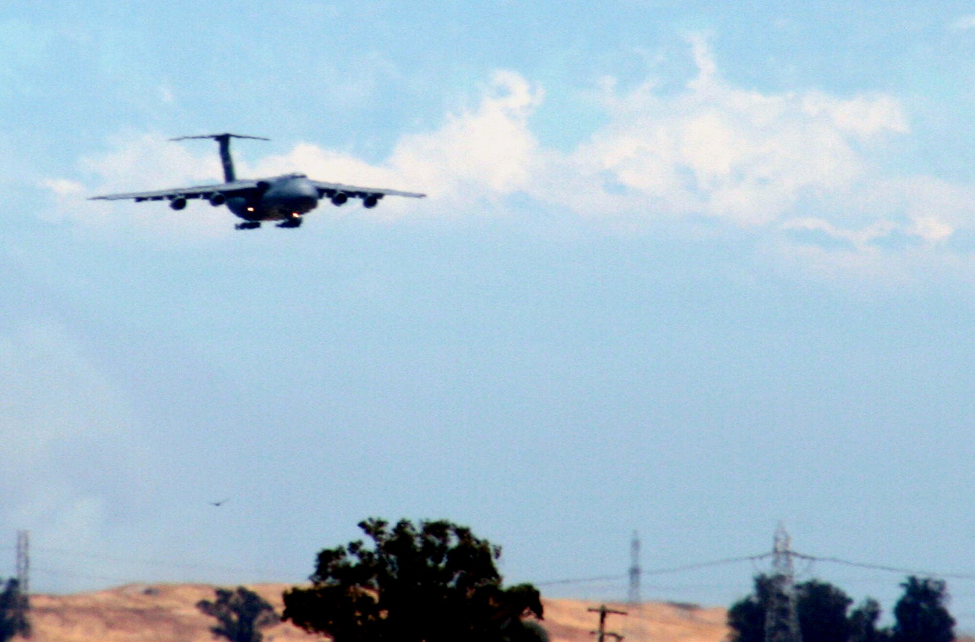 A C-5 Galaxy from the 60th Air Mobility Wing comes in for a landing at Travis Air Force Base, Calif., on Aug. 5, 2009. The C-5 is Air Mobility Command's and the Air Force's largest airlift plane.  The C-5 can carry more than any other airlifter. It has the ability to carry 36 standard pallets and up to 81 troops simultaneously. (U.S. Air Force Photo/Tech. Sgt. Scott T. Sturkol)