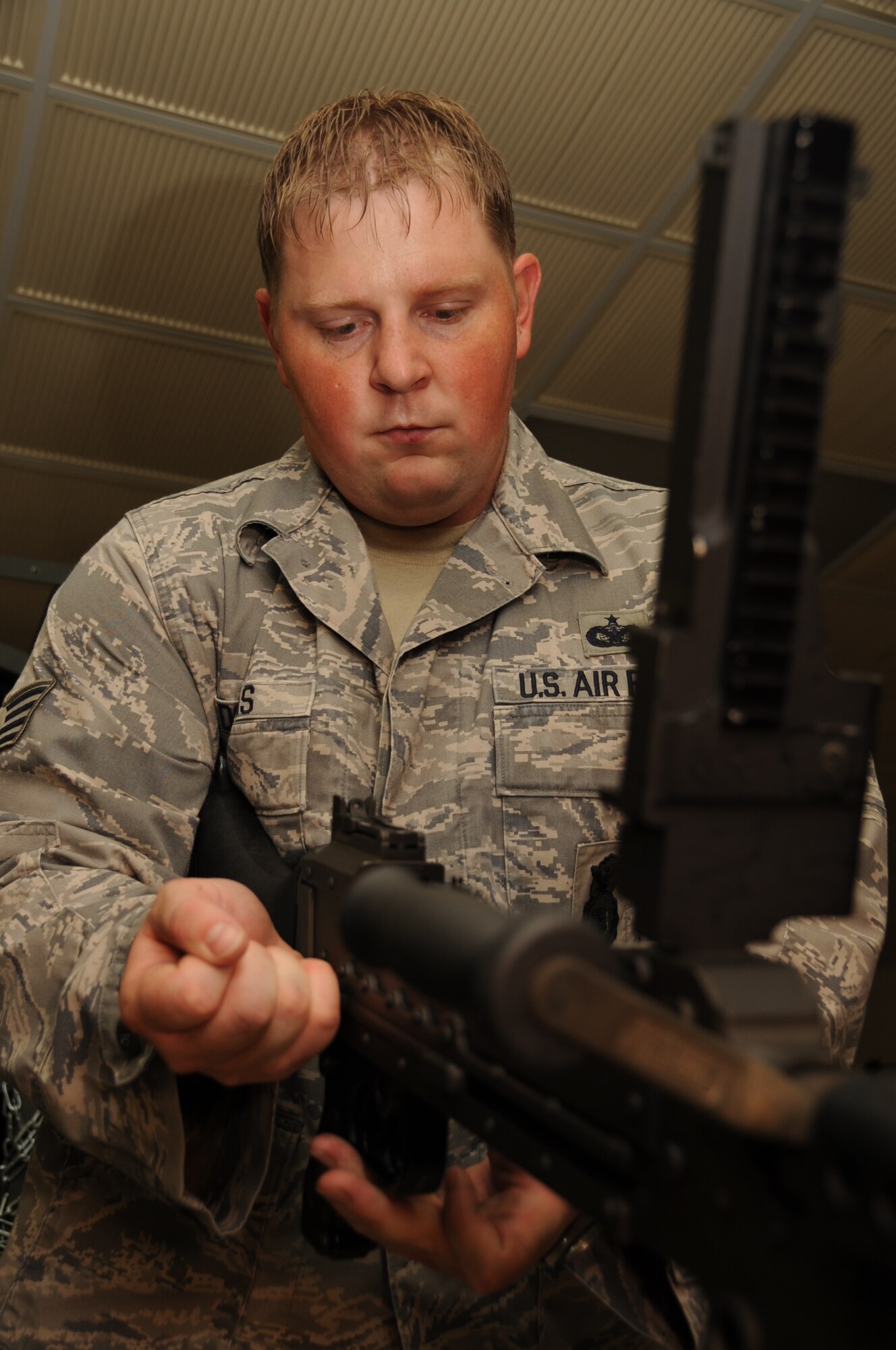 Staff Sgt. Jeremy Douglas, 28th Security Forces Squadron armory NCO in charge, clears an M-249 Semi-Automatic Weapon here, August 6.  The M-249 SAW is cleared to ensure the weapon is not stored while still loaded. (U.S. Air Force photo/Airman 1st Class Anthony Sanchelli)