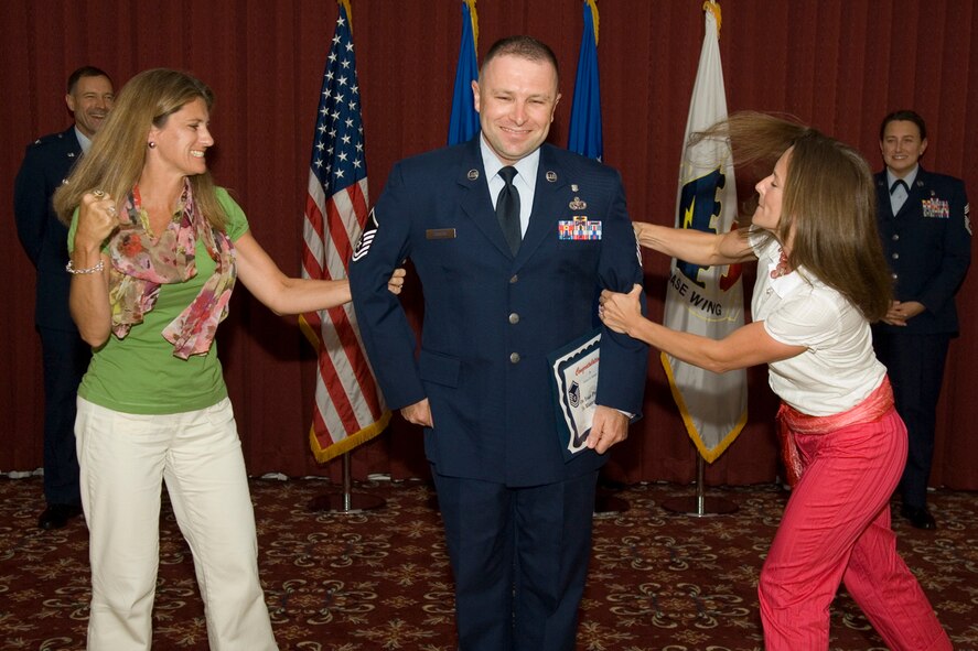 HANSCOM AIR FORCE BASE, Mass. - Master Sgt. Michael Shimkus, 66th Medical Support Squadron, receives his new master sergeant rank from his sisters Kimberly Russell and Kathryne Freiss during a promotion ceremony held at the Minuteman Club July 31. (U.S. Air Force photo by Rick Berry)