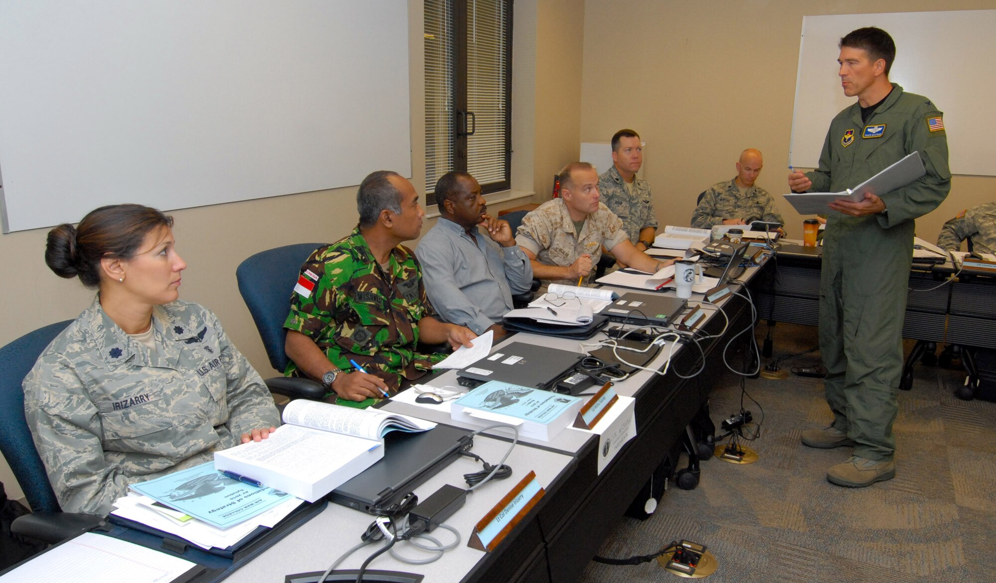 The Spaatz Center's Air War College, the senior Air Force military school, welcomed 238 students into a new class that began July 27 and will graduate in May of 2010. In addition to Air Force officers, the class includes officers from all U.S. military branches as well as 45 international officers. Eighteen civilians are also attending. Seminar instructor Col. Chuck Eastman talks with students (from left) Lt. Col. Denise Irizarry, Col. Wishnu Sukardjo from Indonesia, civilian Randy Caves, Marine Lt. Col. Mike Scalise and Lt. Col. Dan Daniels. (U.S. Air Force photo) 