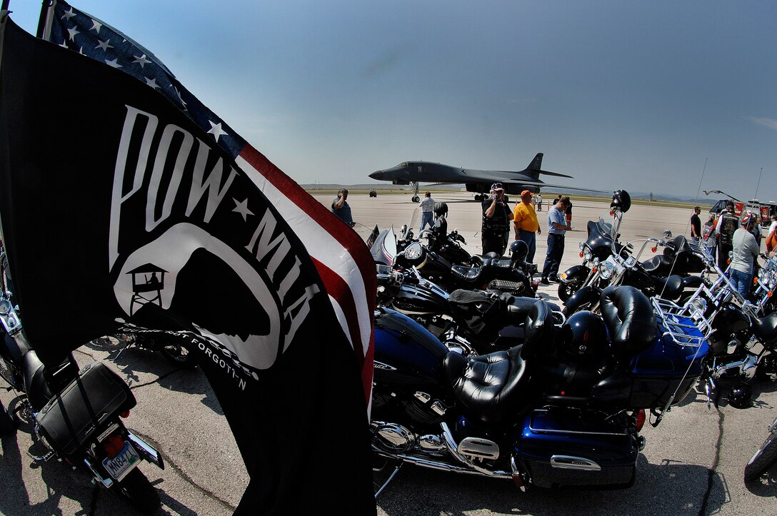 Motorcycles line up in front of a B-1B Lancer before the Ninth Annual Dakota Thunder Motorcycle Run here, August 4. The POW/MIA flag, which was created in 1971 during the Vietnam War, honors all veterans who were held as POW's or listed MIA. (U.S. Air Force photo/Airman 1st Class Joshua J. Seybert)
