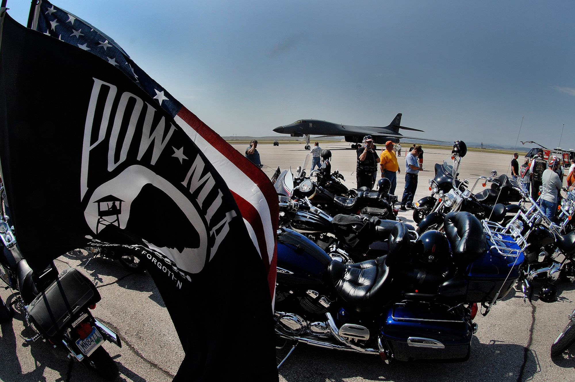 Motorcycles line up in front of a B-1B Lancer before the Ninth Annual Dakota Thunder Motorcycle Run here, August 4. The POW/MIA flag, which was created in 1971 during the Vietnam War, honors all veterans who were held as POW's or listed MIA. (U.S. Air Force photo/Airman 1st Class Joshua J. Seybert)