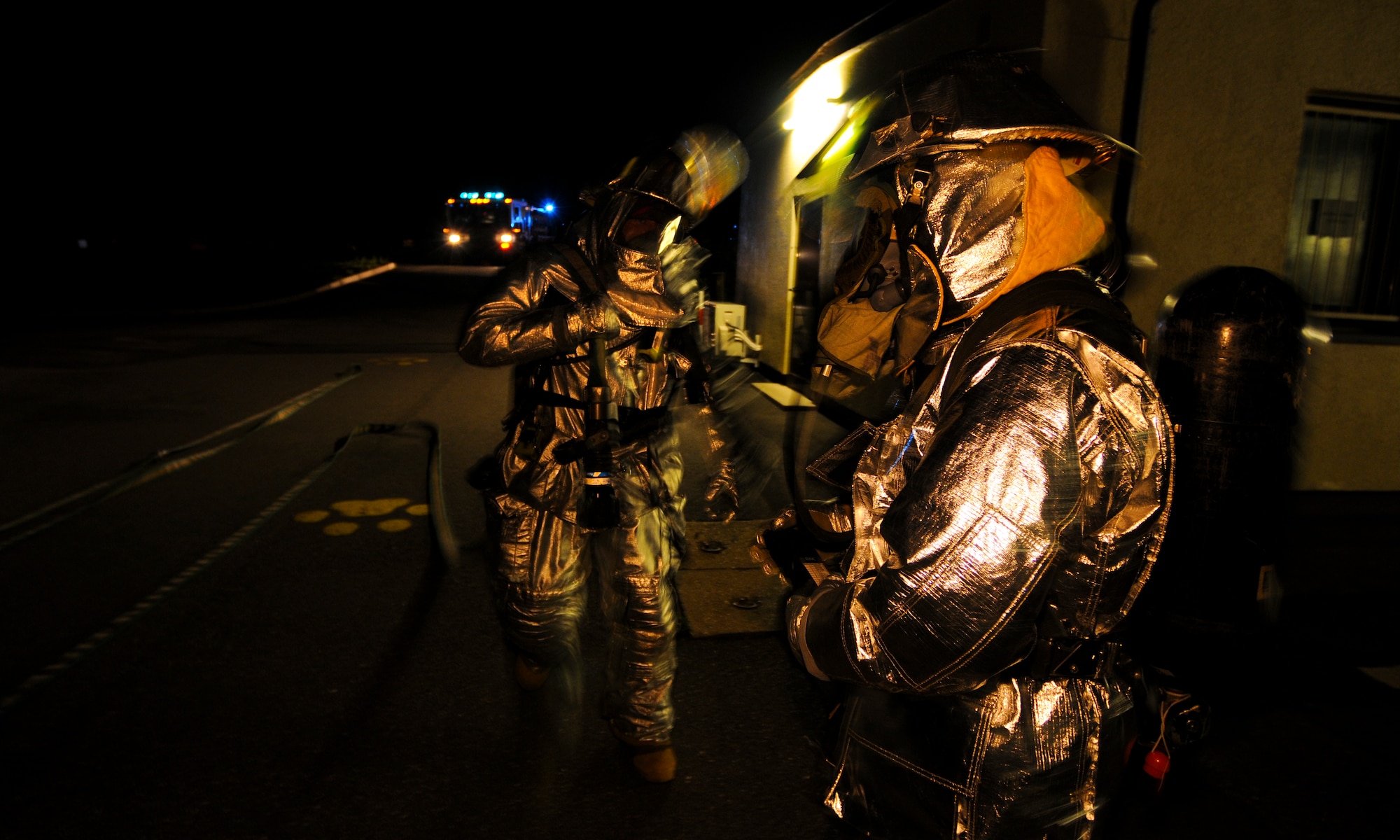 SPANGDAHLEM AIR BASE, Germany -- Firefighters from the 52nd Civil Engineer Squadron discuss the best method to fight a simulated building fire at the 81st Fighter Squadron Aug. 5. The simulation was part of the 52nd Fighter Wing’s Phase II exercise to prepare for a NATO Tactical Evaluation in June 2010. (U.S. Air Force photo/Airman 1st Class Nathanael Callon)