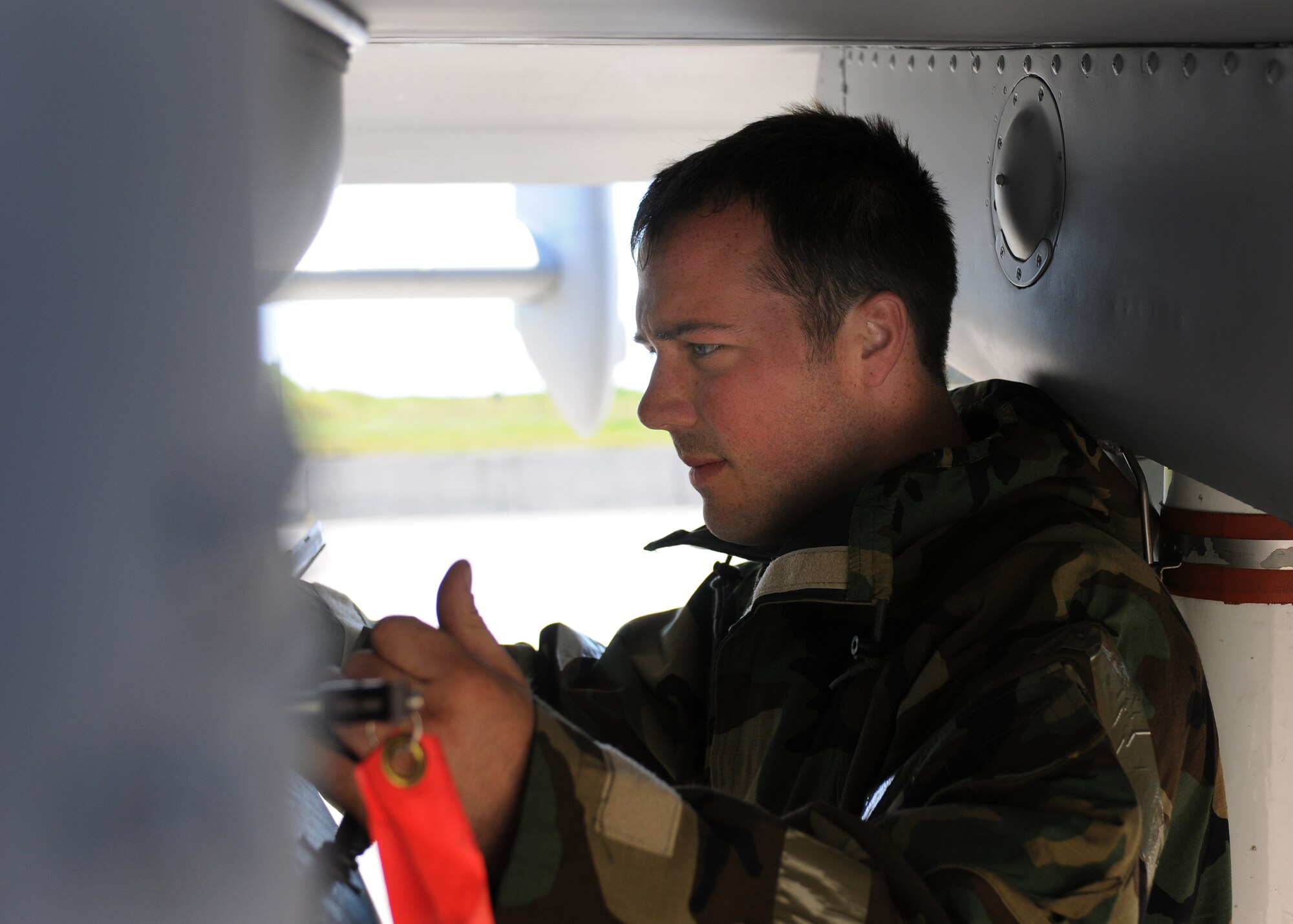 SPANGDAHLEM AIR BASE, Germany -- Senior Airman Joshua Harris, 81st Aircraft Maintenance Unit, prepares an A-10 Thunderbolt II for a mission during the Phase II exercise Aug. 5. Members of the 52nd Fighter Wing were required to perform daily functions in a simulated chemical environment during the wing’s Phase II exercise Aug. 4-7. (U.S. Air Force photo/Airman 1st Class Nathanael Callon)